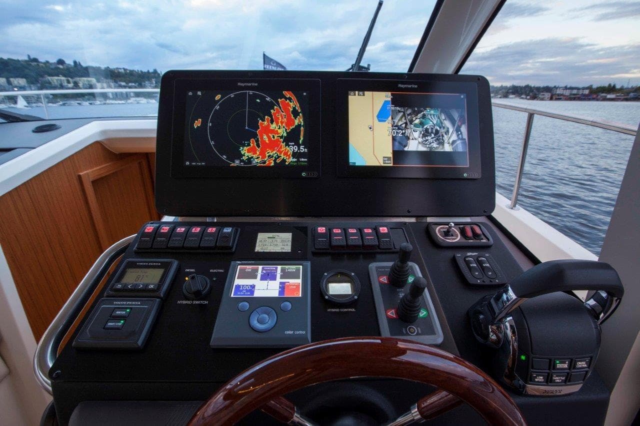 Cockpit of 2026 Greenline 39 Hybrid yacht with navigation screens and controls.