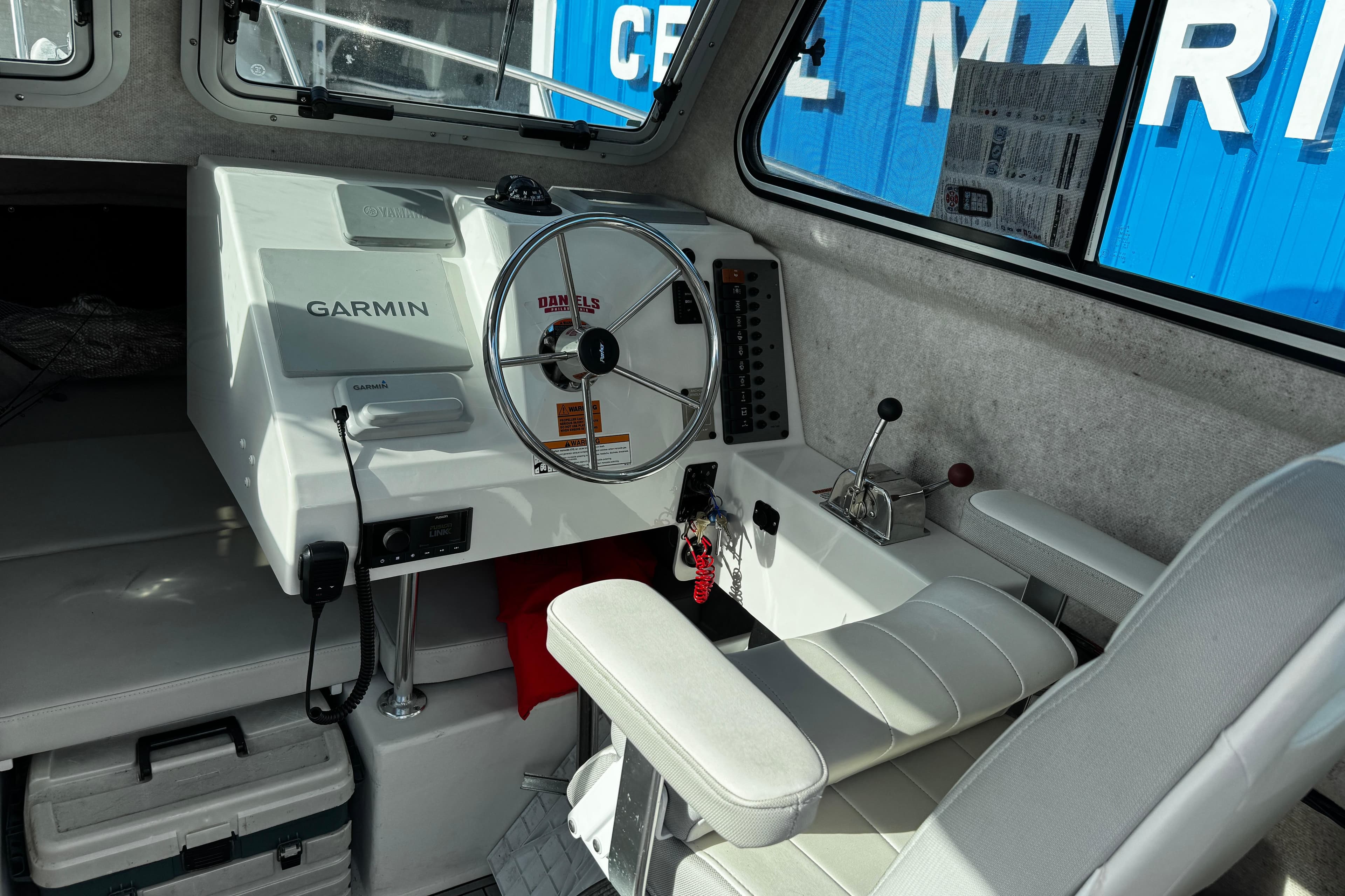 Interior of 2021 Parker 2320 Sport Cabin with Garmin navigation system and steering wheel.