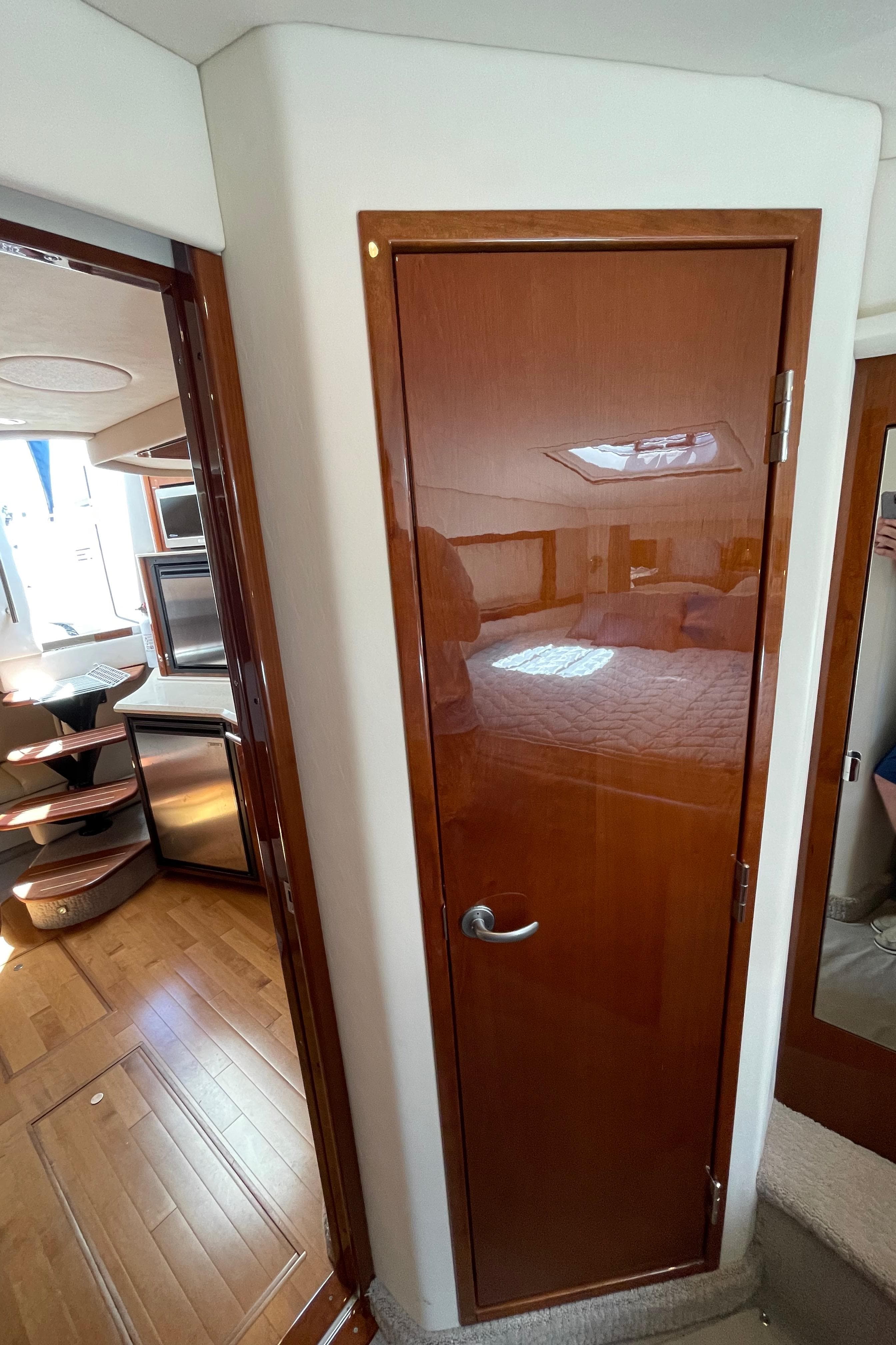 Interior view of 2011 Sea Ray 390 Sundancer yacht, featuring wooden door and modern design.