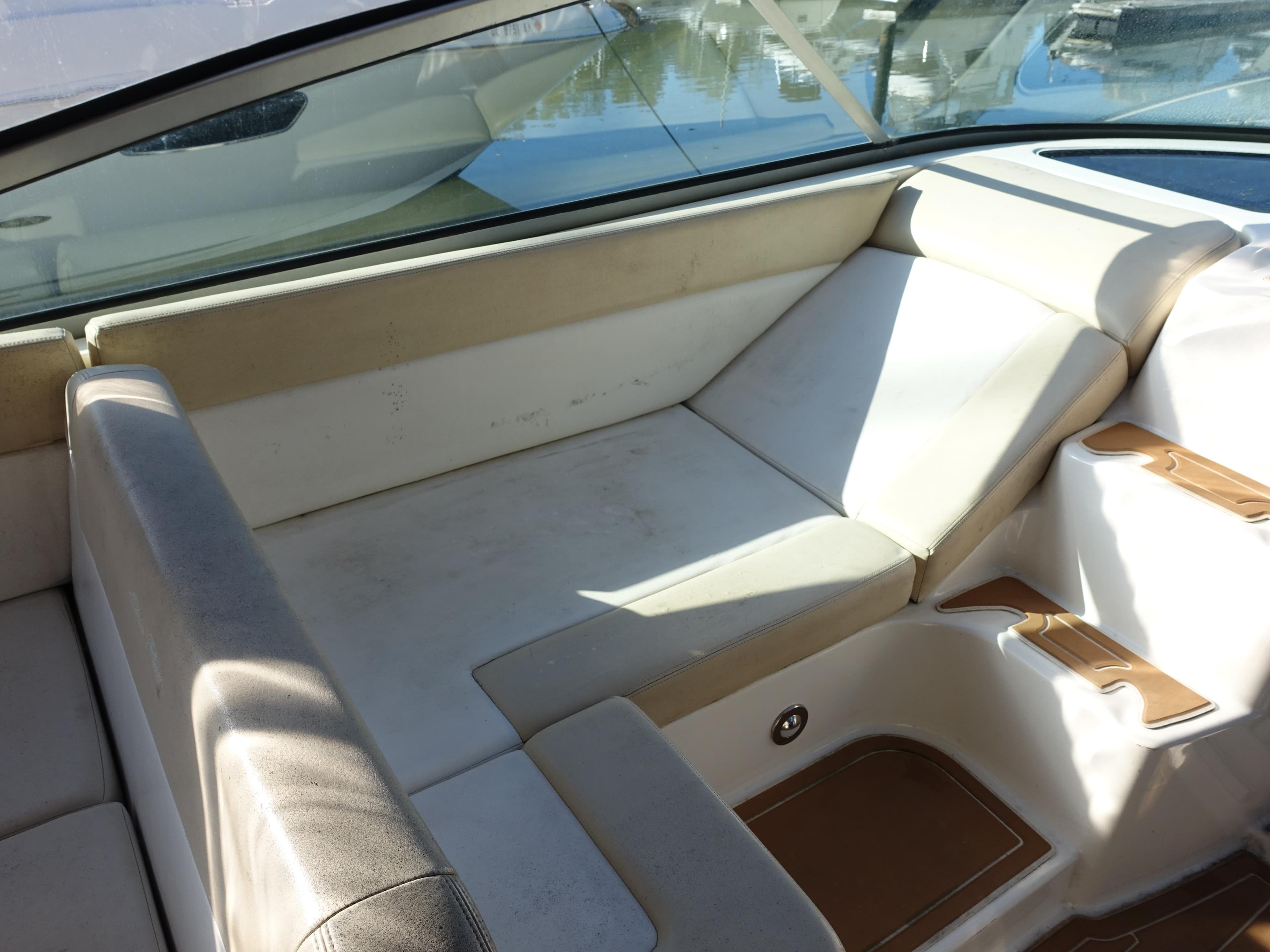 2013 Sea Ray 370 Venture boat interior with beige seating and cup holders.