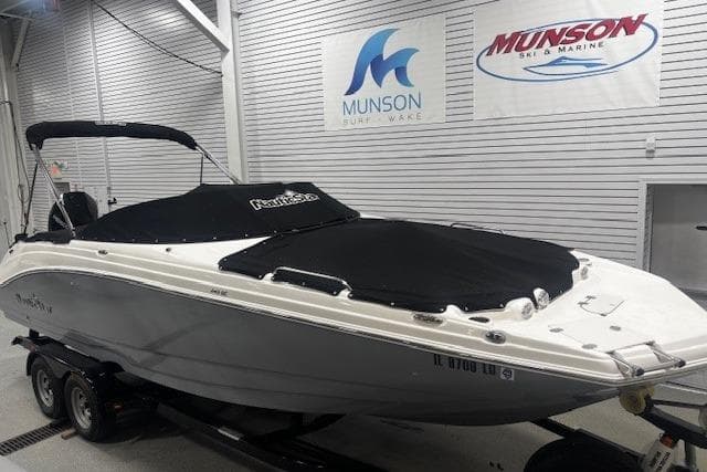2023 NauticStar 243DC Sport Deck boat in showroom with protective cover.