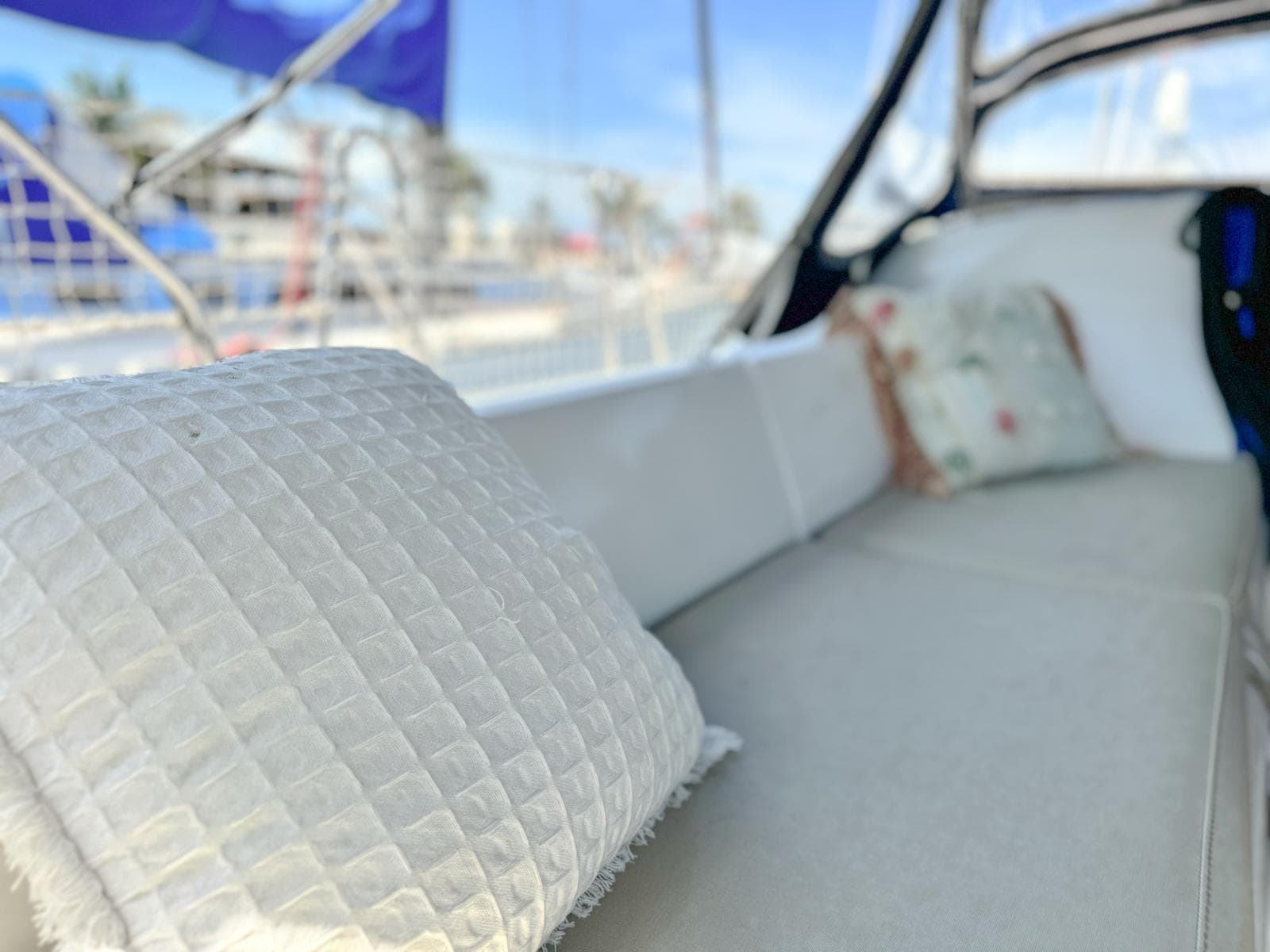 Cozy seating area on a 2006 Beneteau Oceanis 473 sailboat with cushions.
