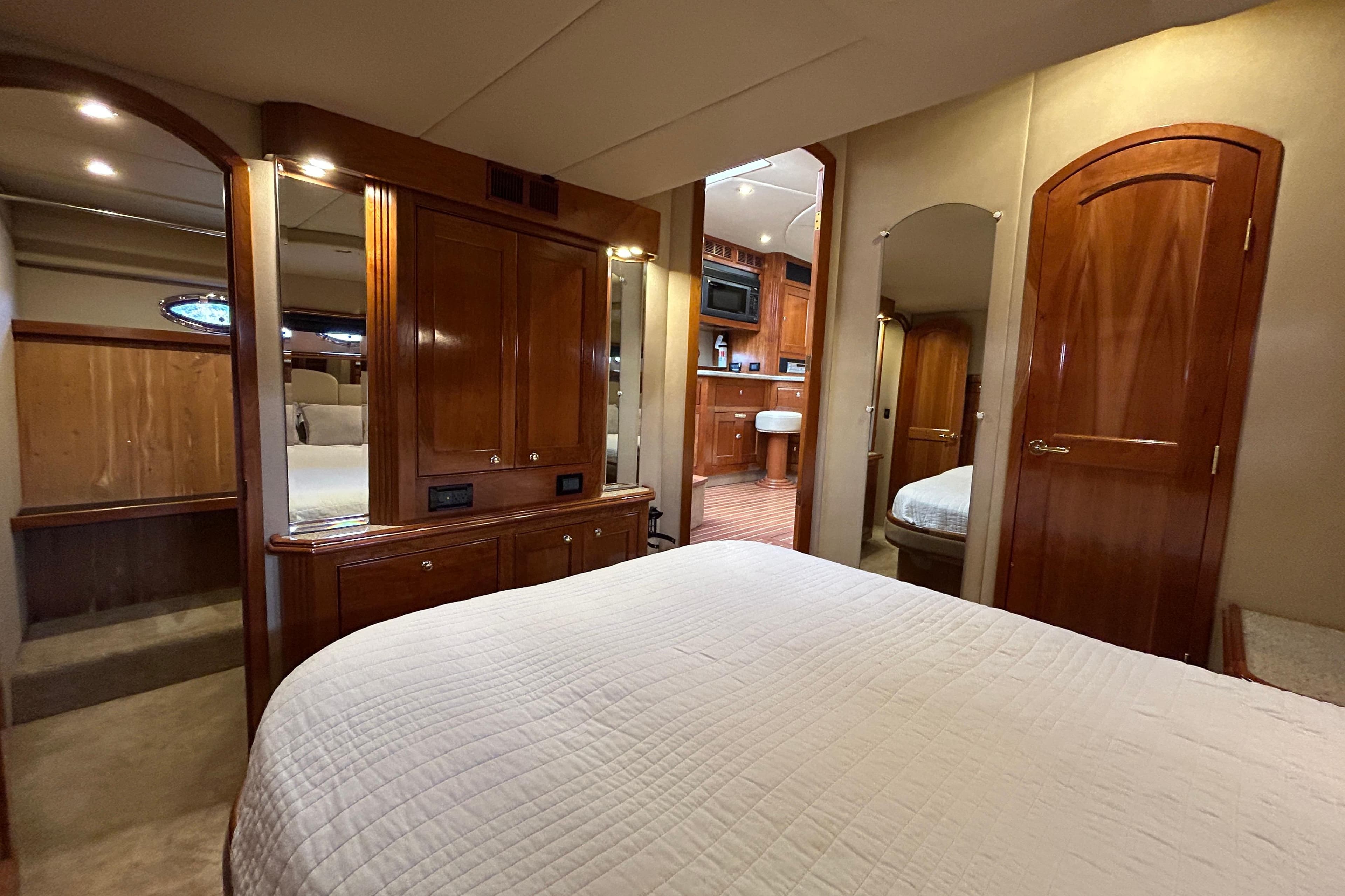 Luxurious 2003 Cruisers Yachts 540 Express interior with elegant wood finishes and cozy bedroom.