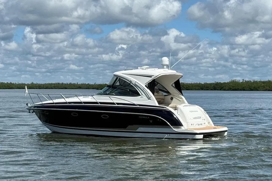 2016 Formula 37 Performance Cruiser on calm water under cloudy sky.