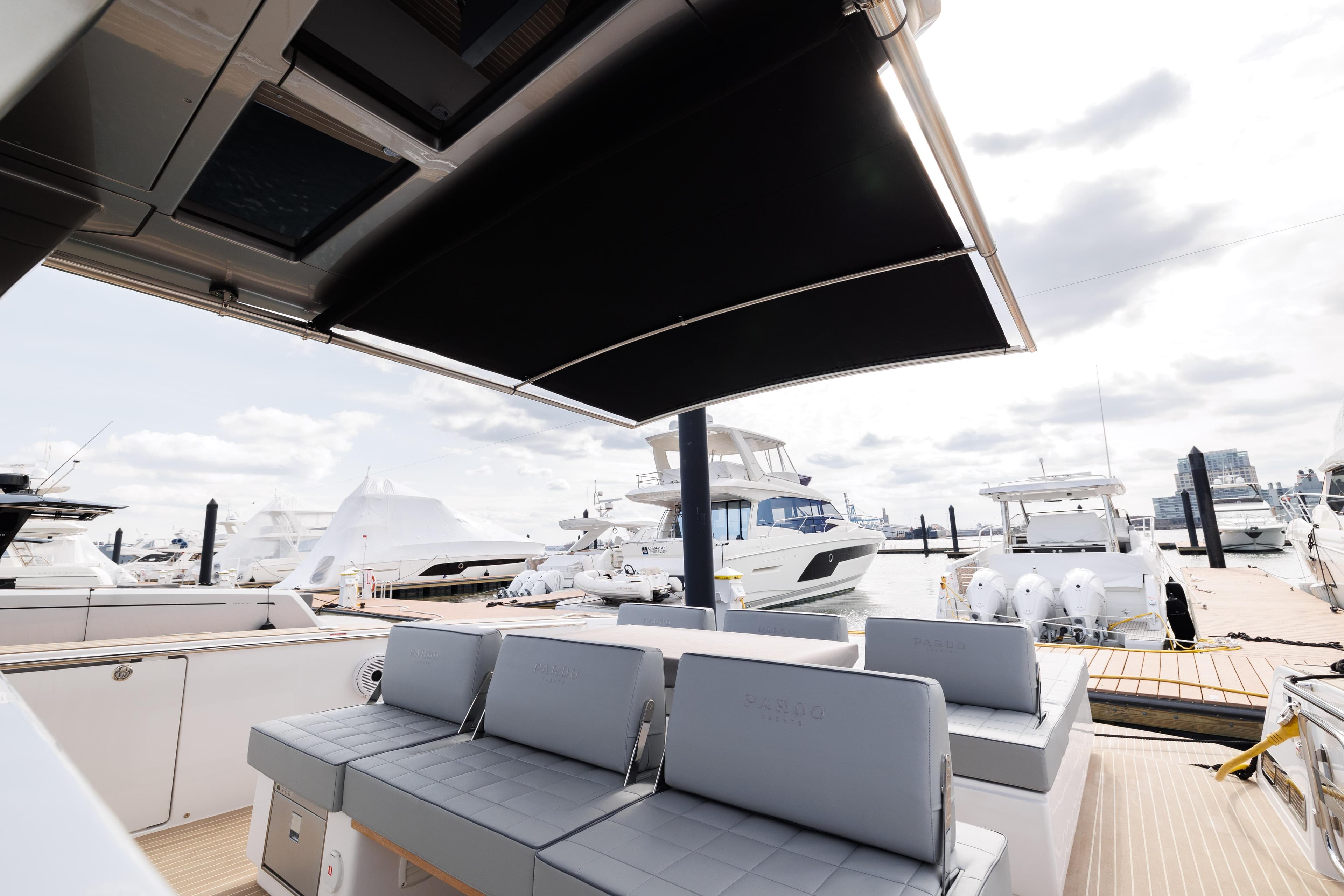 2024 Pardo Yachts 43 luxury yacht with shaded seating area at marina.