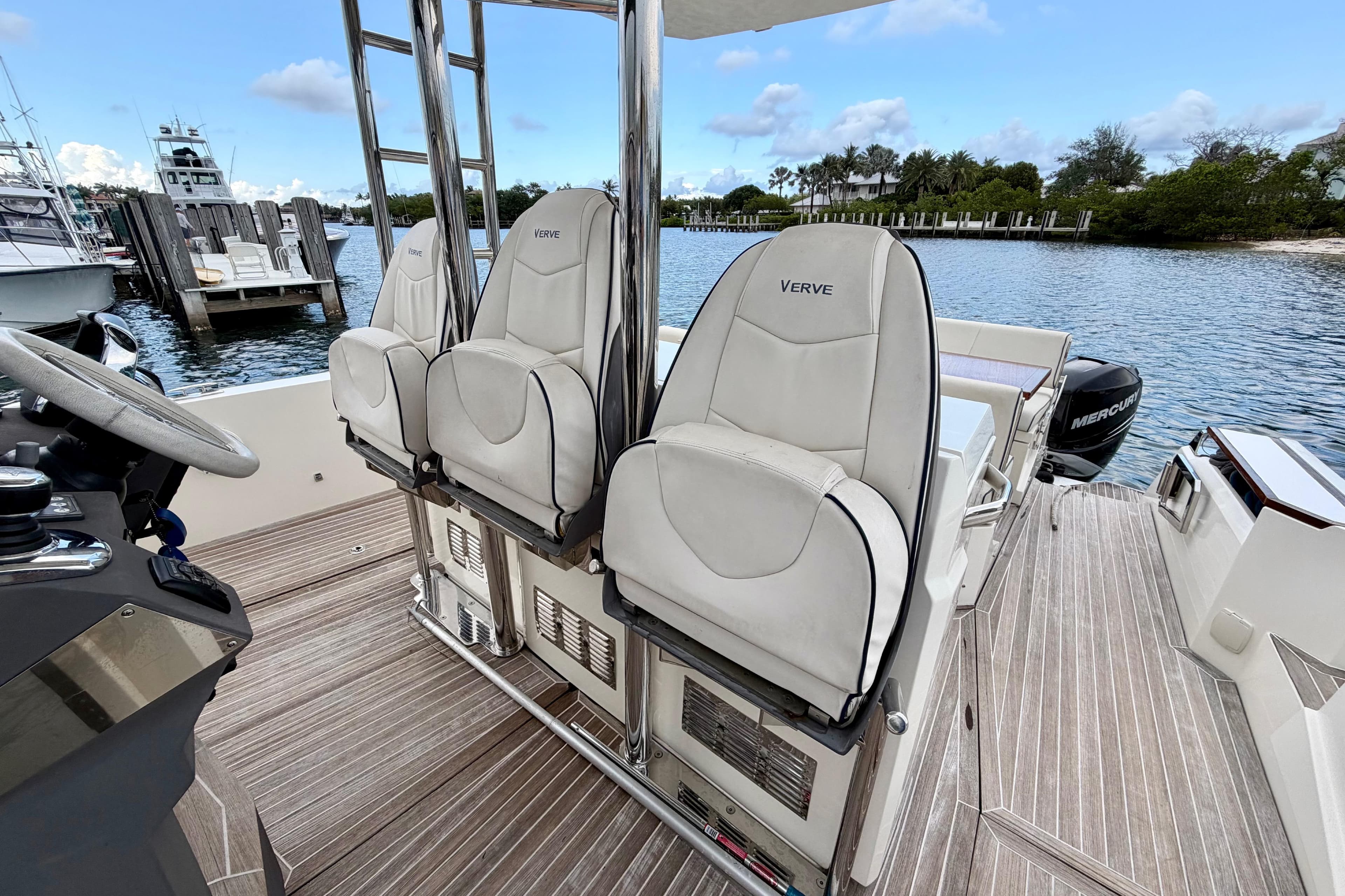 2014 Azimut Verve 40 yacht interior with white seats and wooden deck.