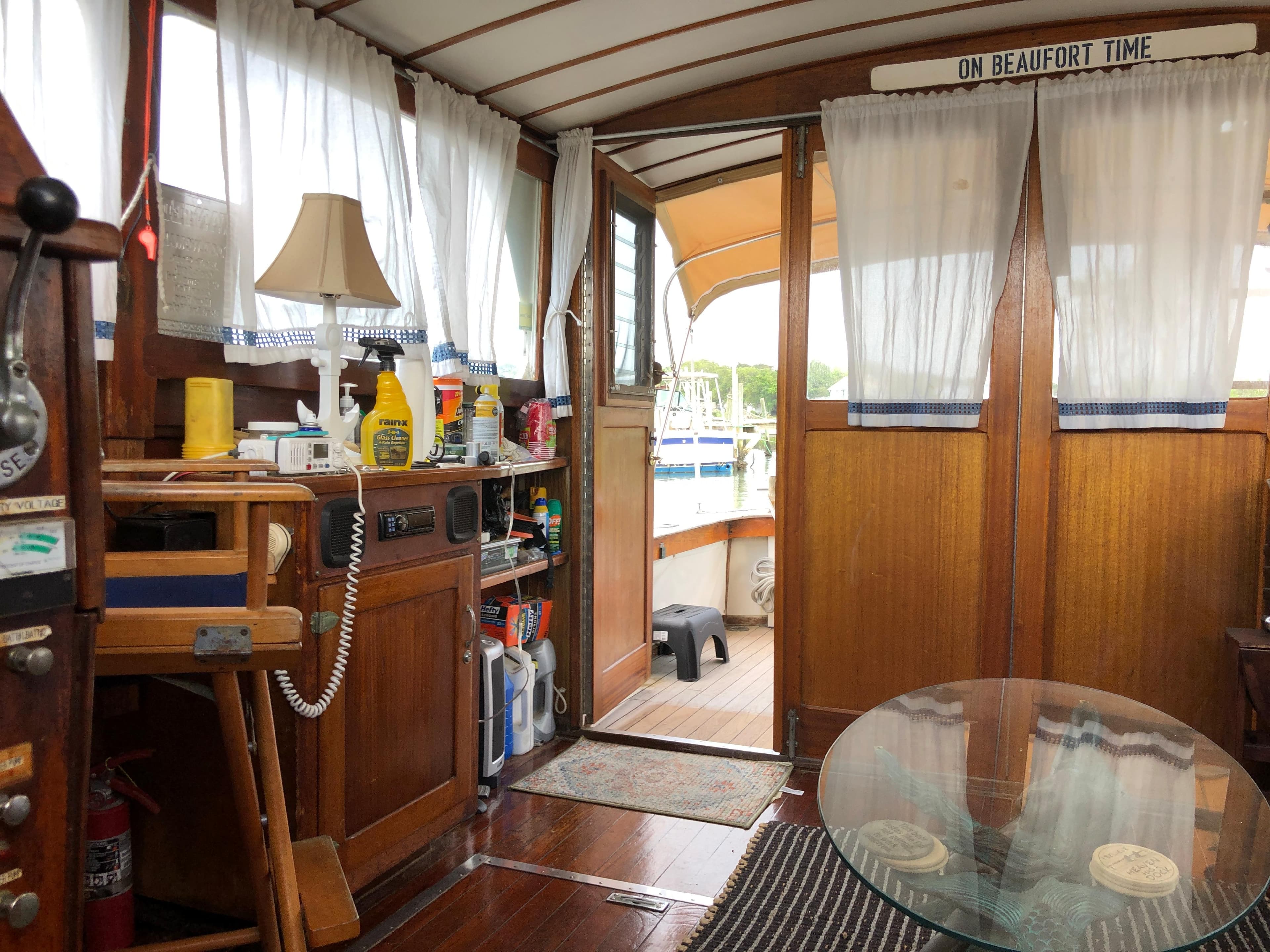 Interior of a 1963 Egg Harbor Convertible Cruiser with wooden decor and nautical elements.