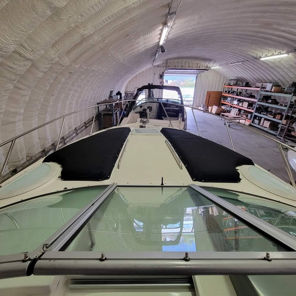 2010 Bayliner 335 boat in storage, inside a spacious, well-lit garage.