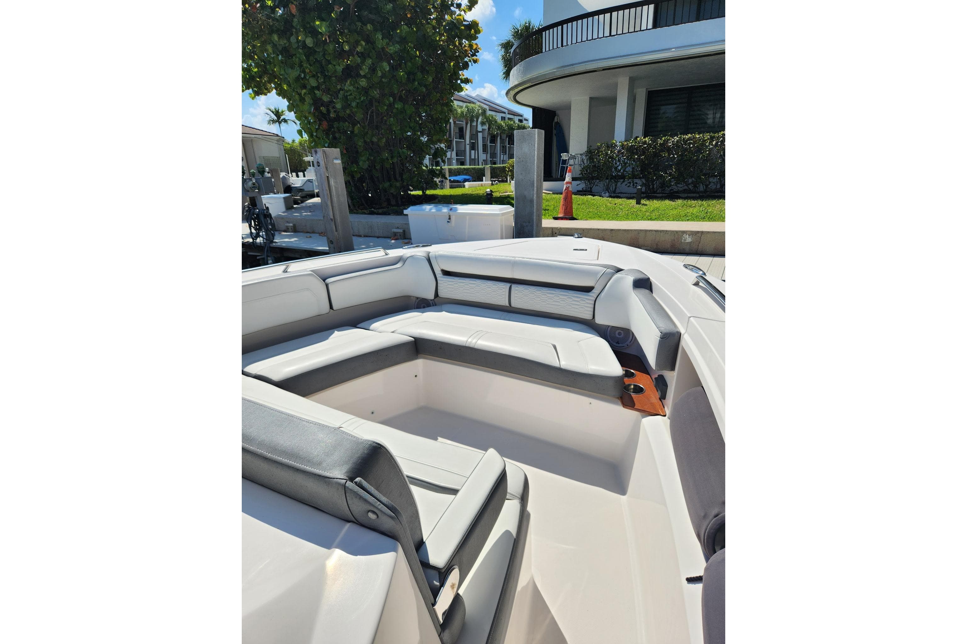 2019 Tiara Sport 38 LS boat interior with cushioned seating and dockside view.