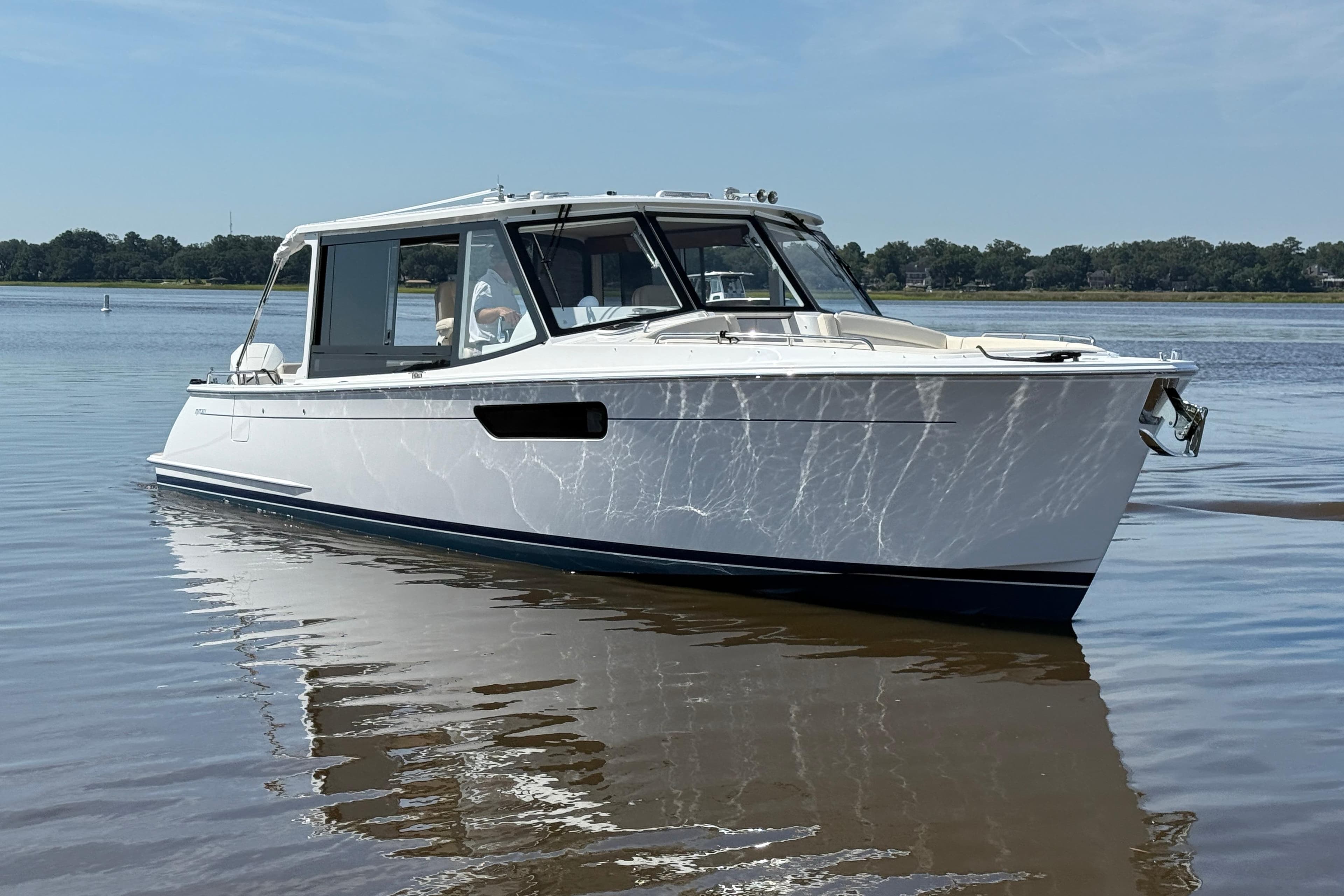 MJM 38x 2026 boat on calm water, showcasing sleek design and modern features.