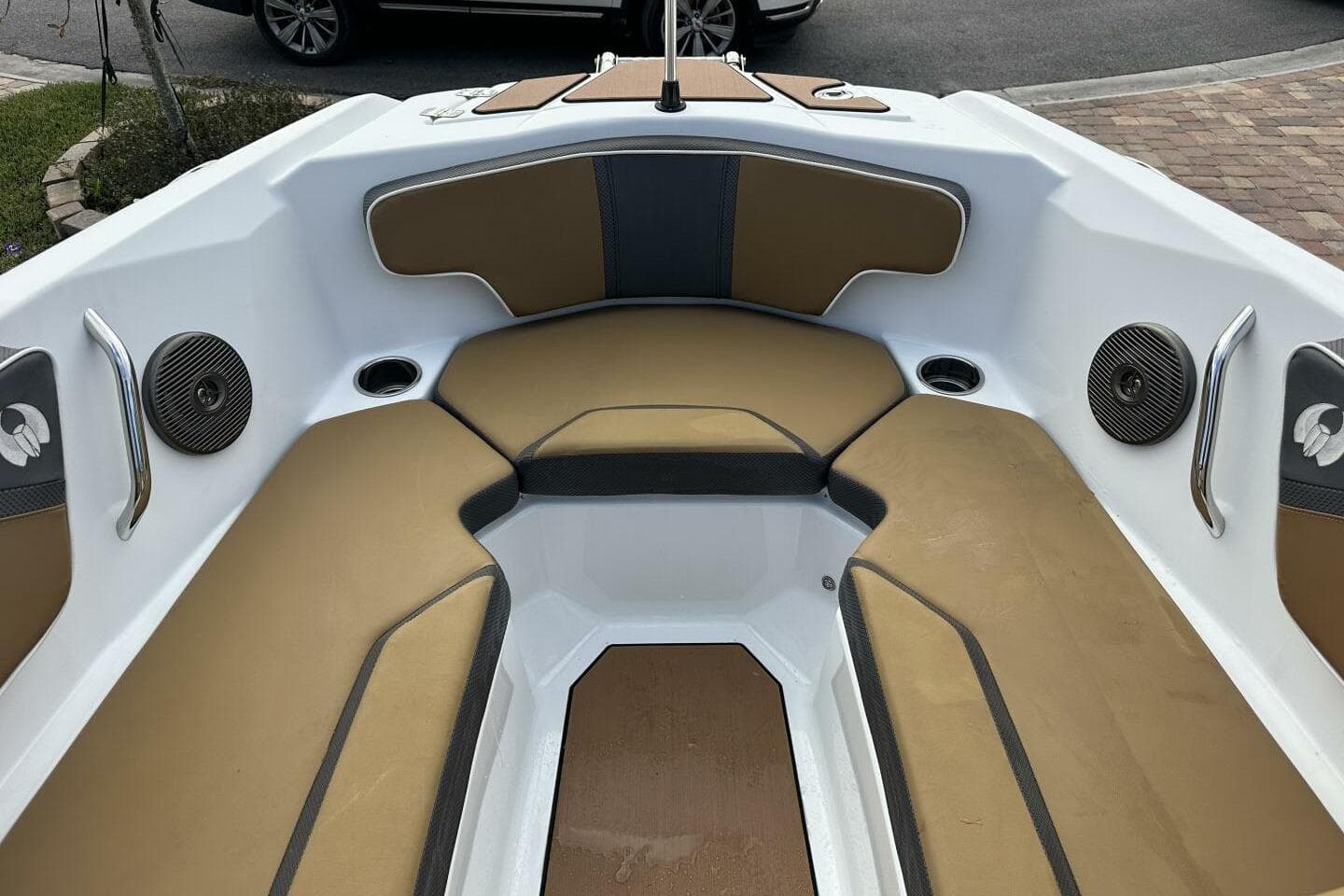 2021 Scarab 215 boat interior with tan seating and built-in speakers.