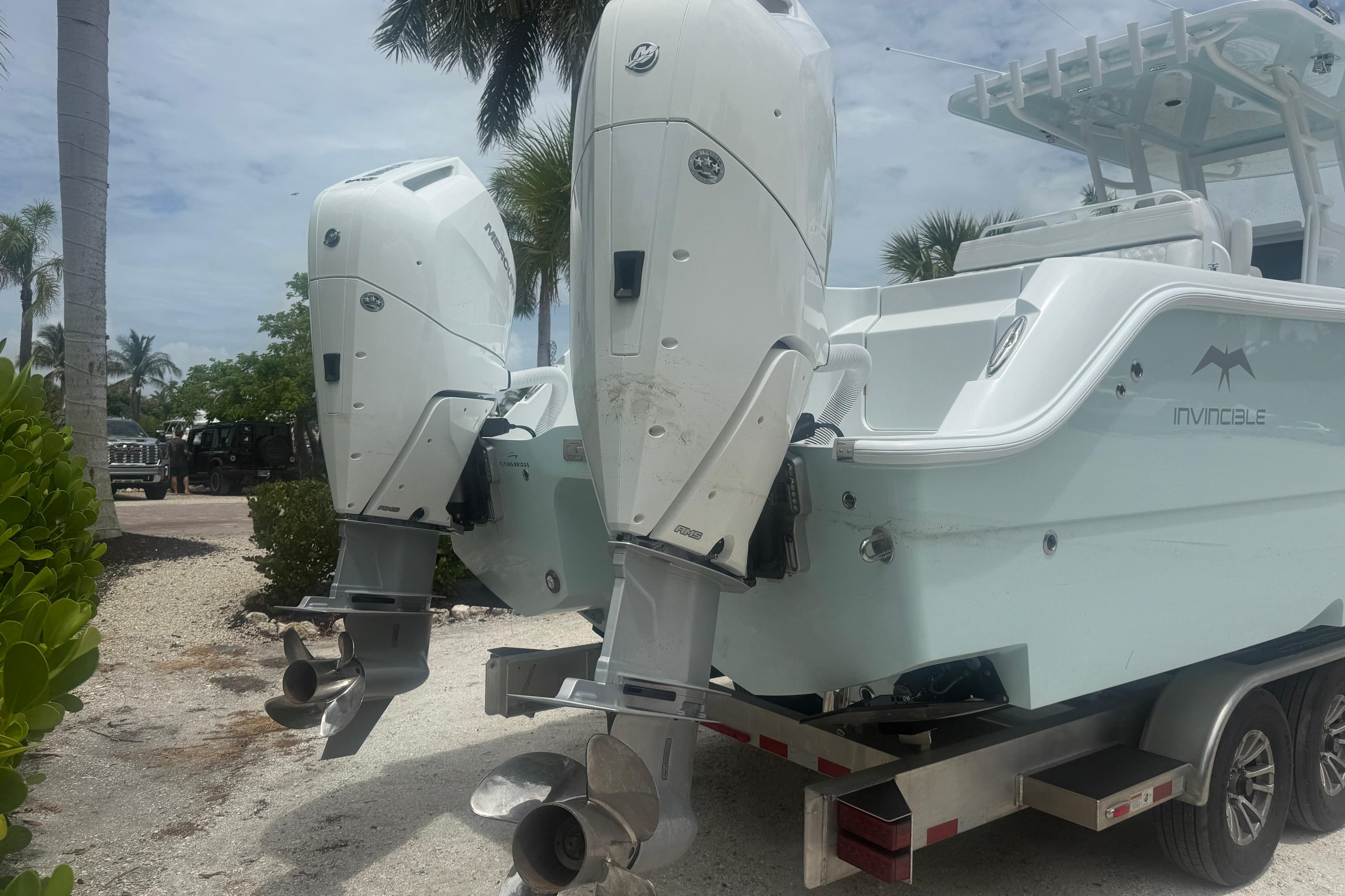 2026 Invincible 33 Catamaran with dual outboard motors on a trailer.