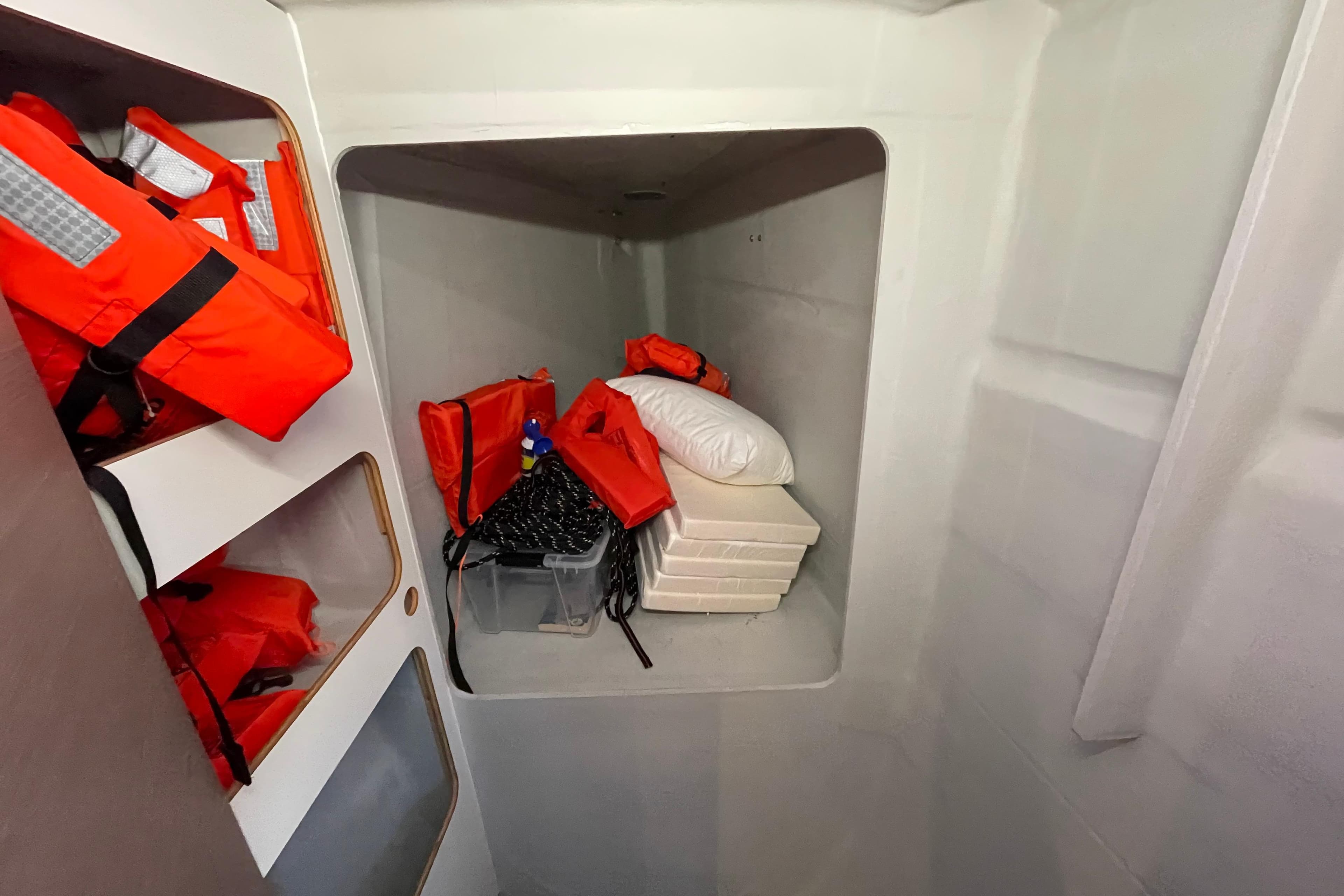 Storage area in 2023 Fountaine Pajot Tanna 47 with life jackets and supplies.