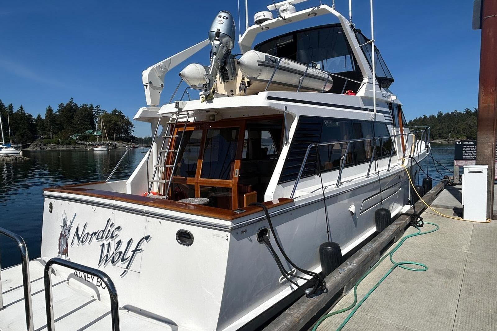 Ocean Alexander 520 Pilothouse yacht docked, 1994 model, named "Nordic Wolf" in scenic marina.