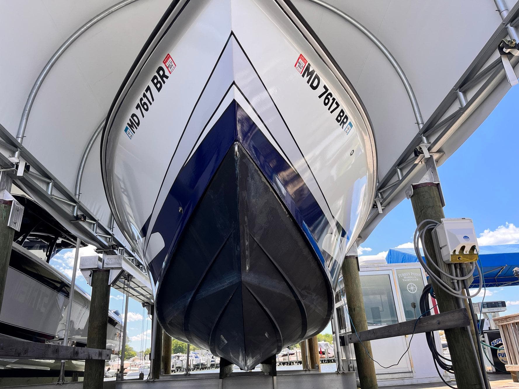 2011 Statement 380 Open boat docked, viewed from below, showcasing sleek hull design.
