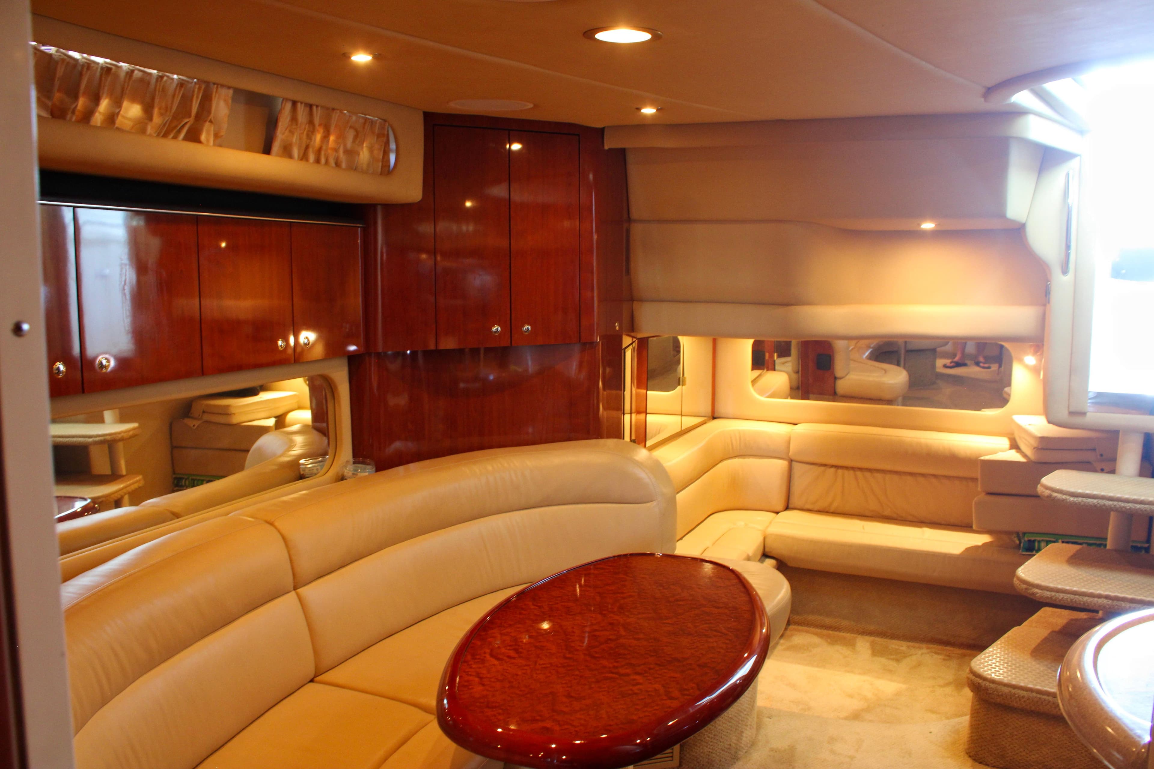 Luxurious interior of a 2003 Sea Ray 380 Sundancer yacht with plush seating.