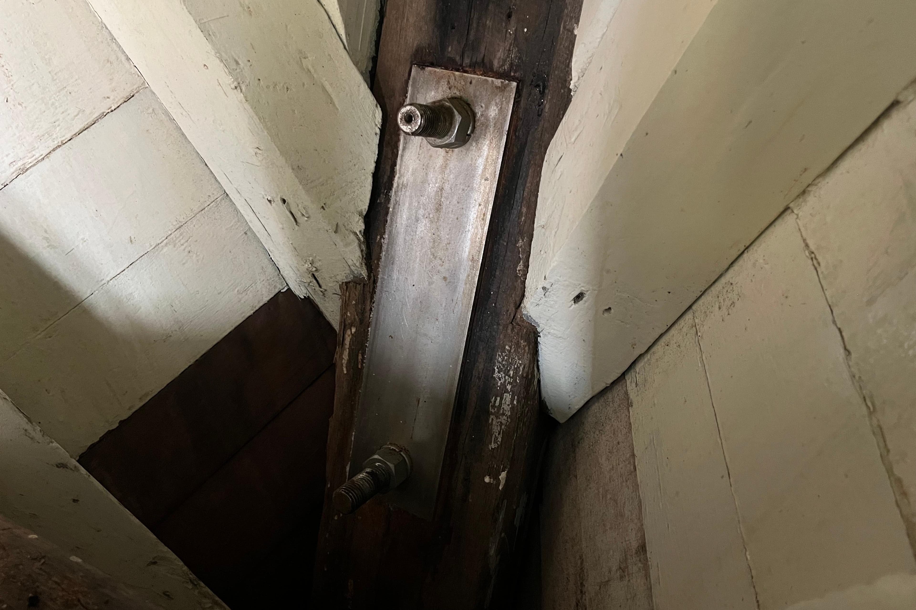Close-up of 1947 Murray Peterson Schooner's wooden interior structure with metal bolts.