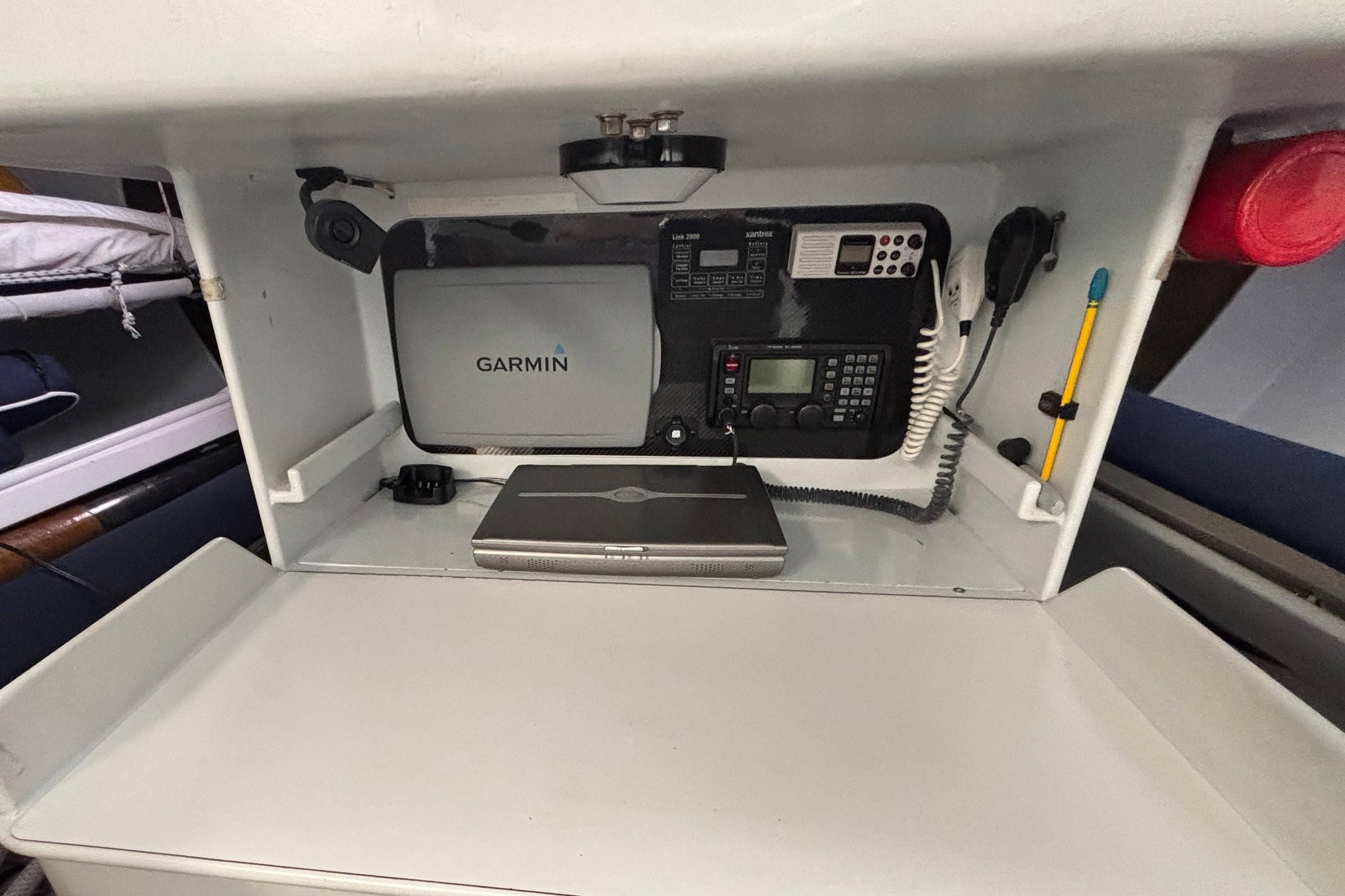 Navigation equipment setup in a 1995 Tripp 47 sailboat, featuring Garmin devices.