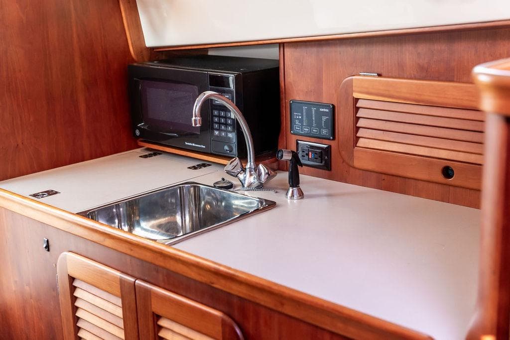 Hinckley Picnic Boat EP 2004 interior with sink, microwave, and control panel.