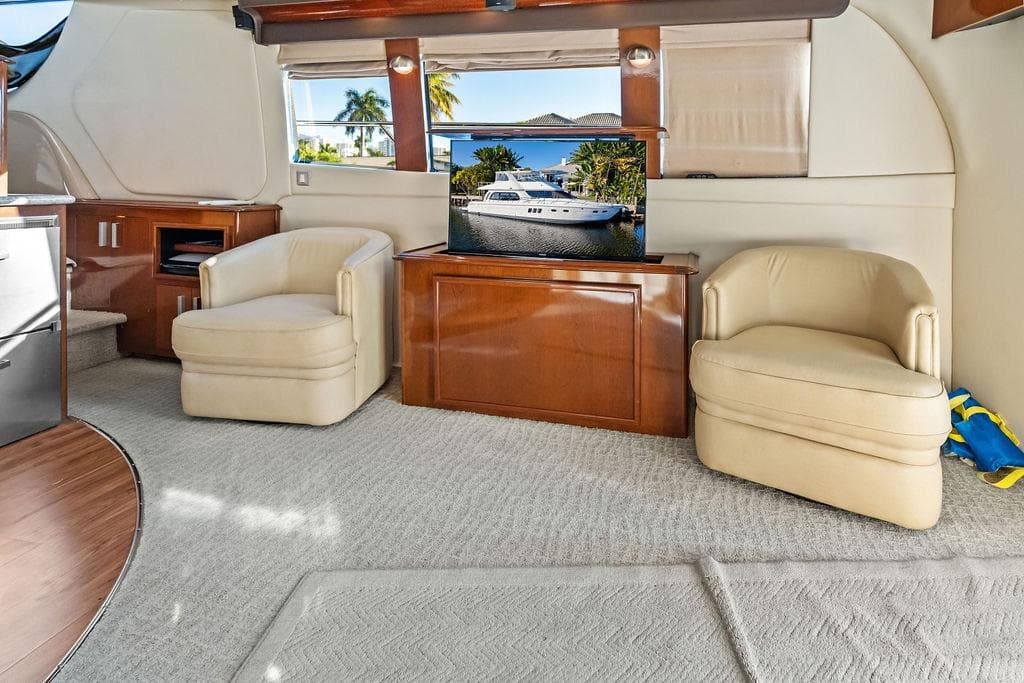 Luxurious interior of 2009 Carver 56 Voyager SE yacht with plush seating and elegant decor.