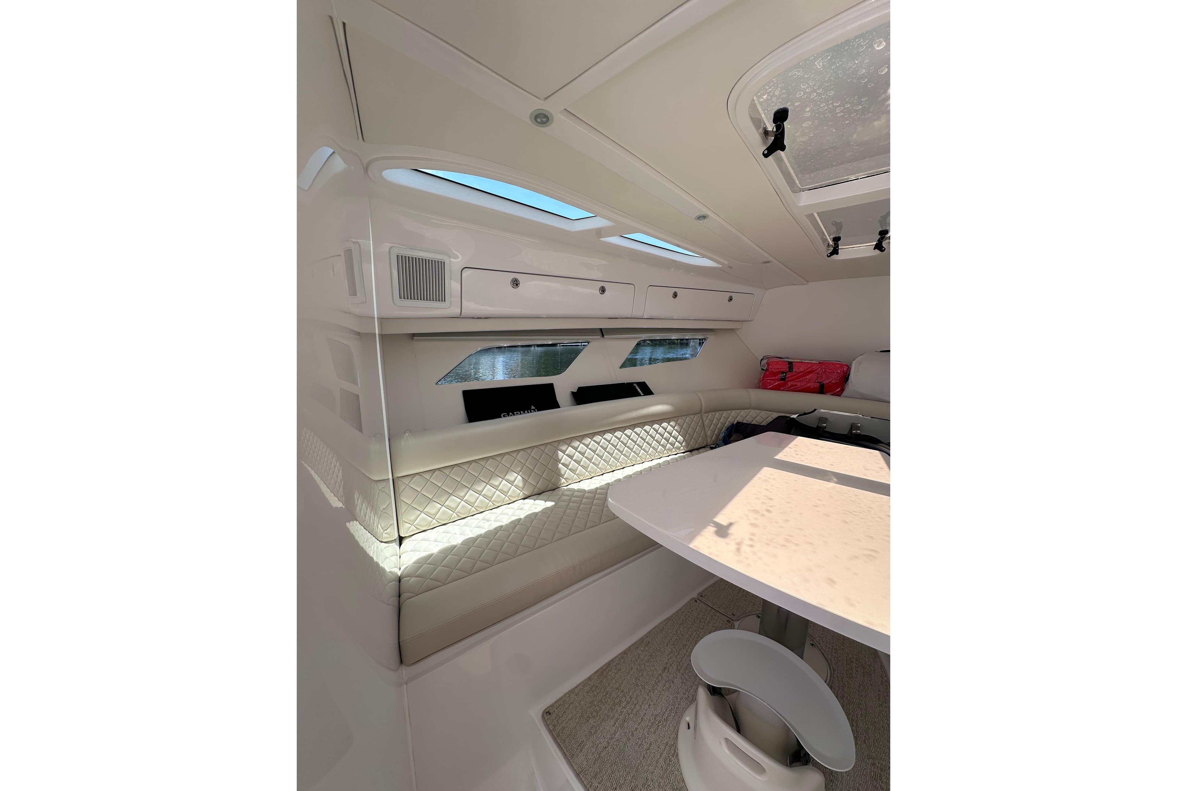Luxurious interior of 2024 Intrepid 41 Valor yacht with elegant seating and table.
