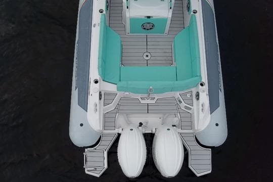 2024 Ranieri Cayman 27.0 Sport boat, aerial view, featuring teal seating and dual engines.