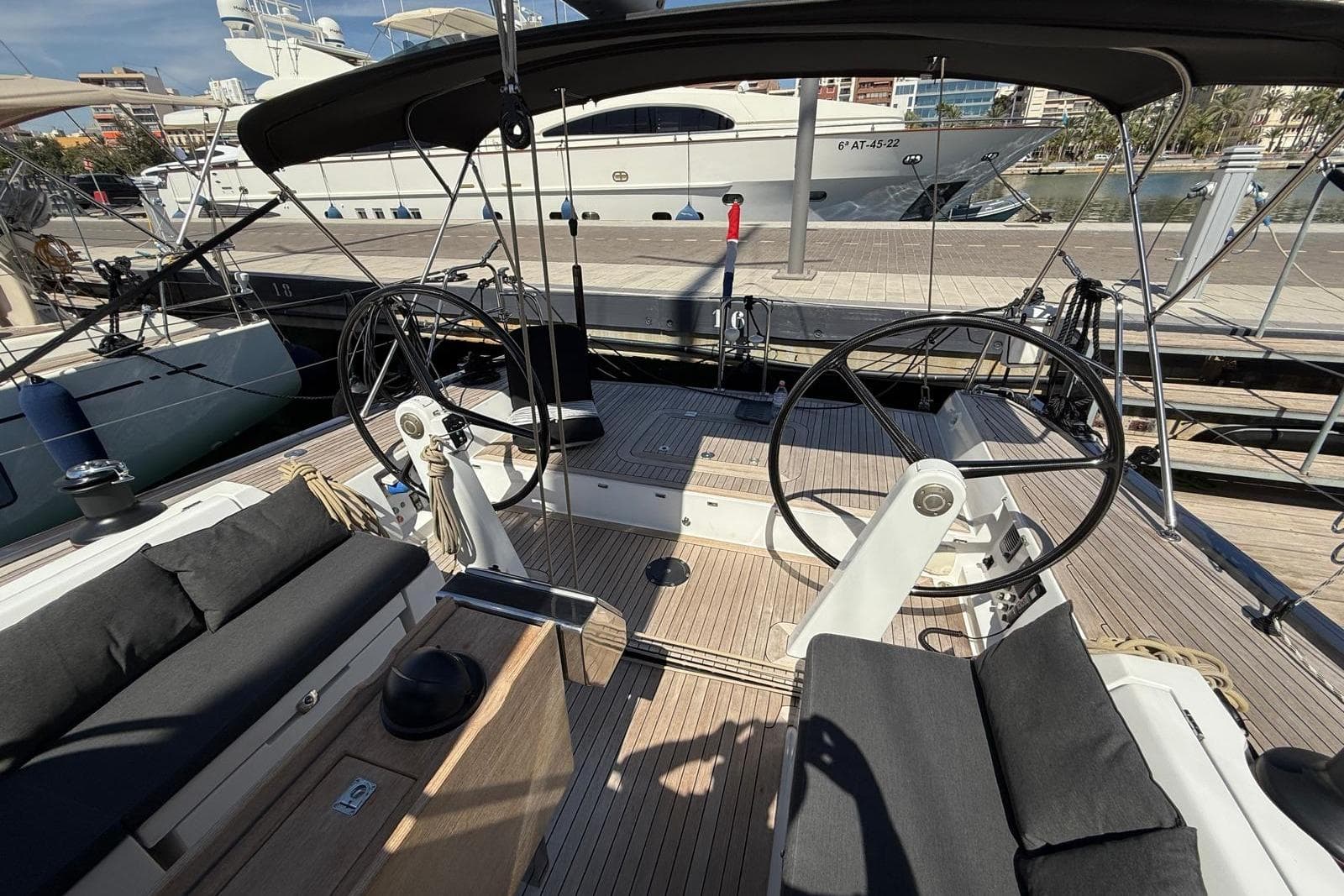 Cockpit of a 2012 Solaris 48 yacht with dual steering wheels and cushioned seating.