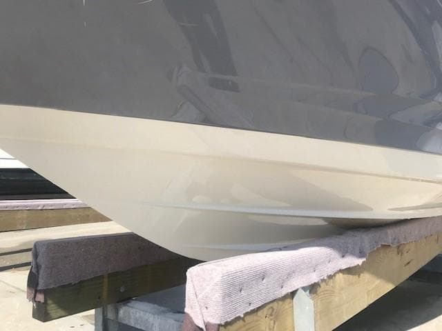 2022 Sea Ray SPX 190 boat hull on a wooden stand.