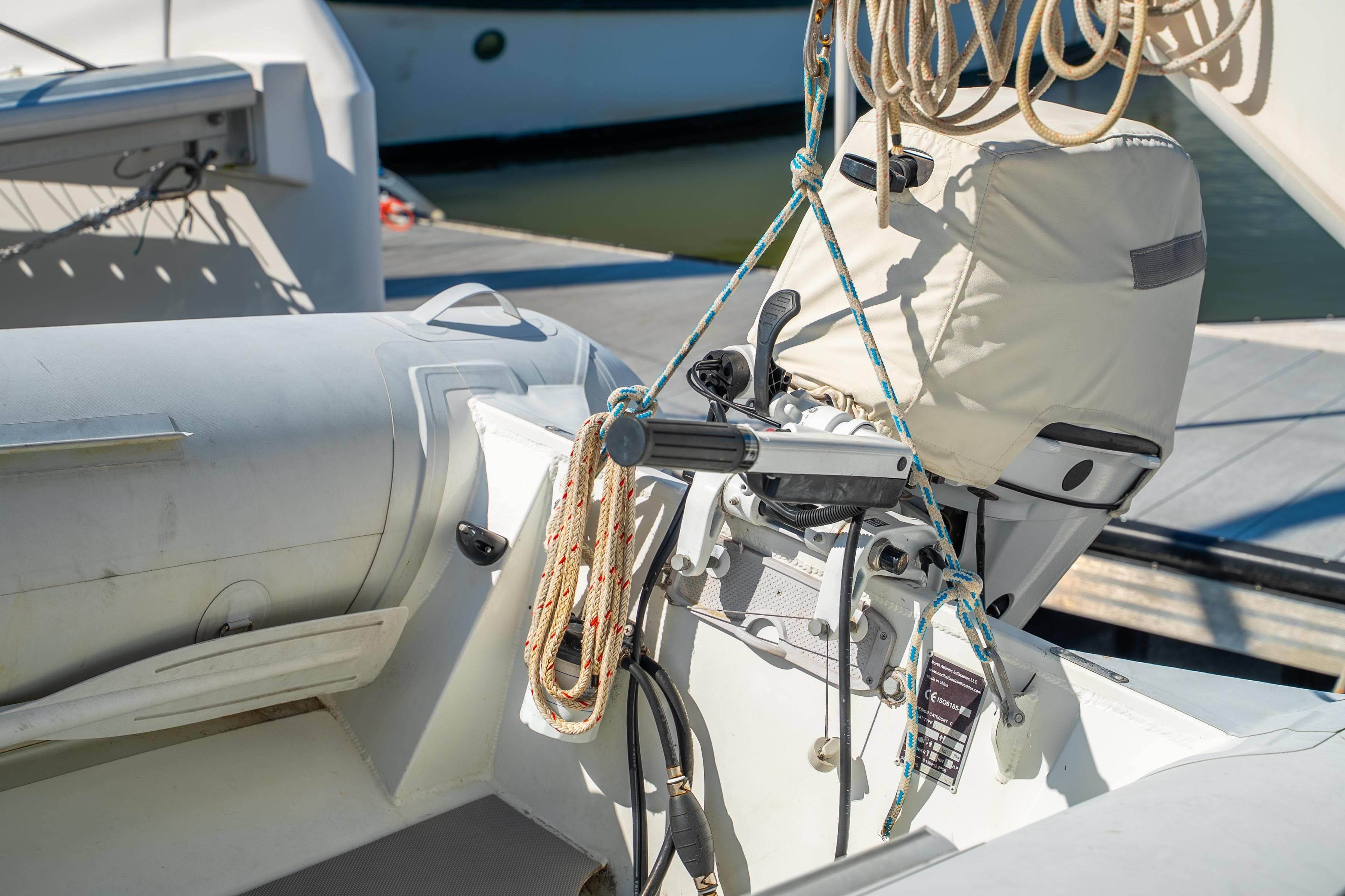 Inflatable boat with motor and ropes, docked near Leopard 46 yacht, 2007 model.