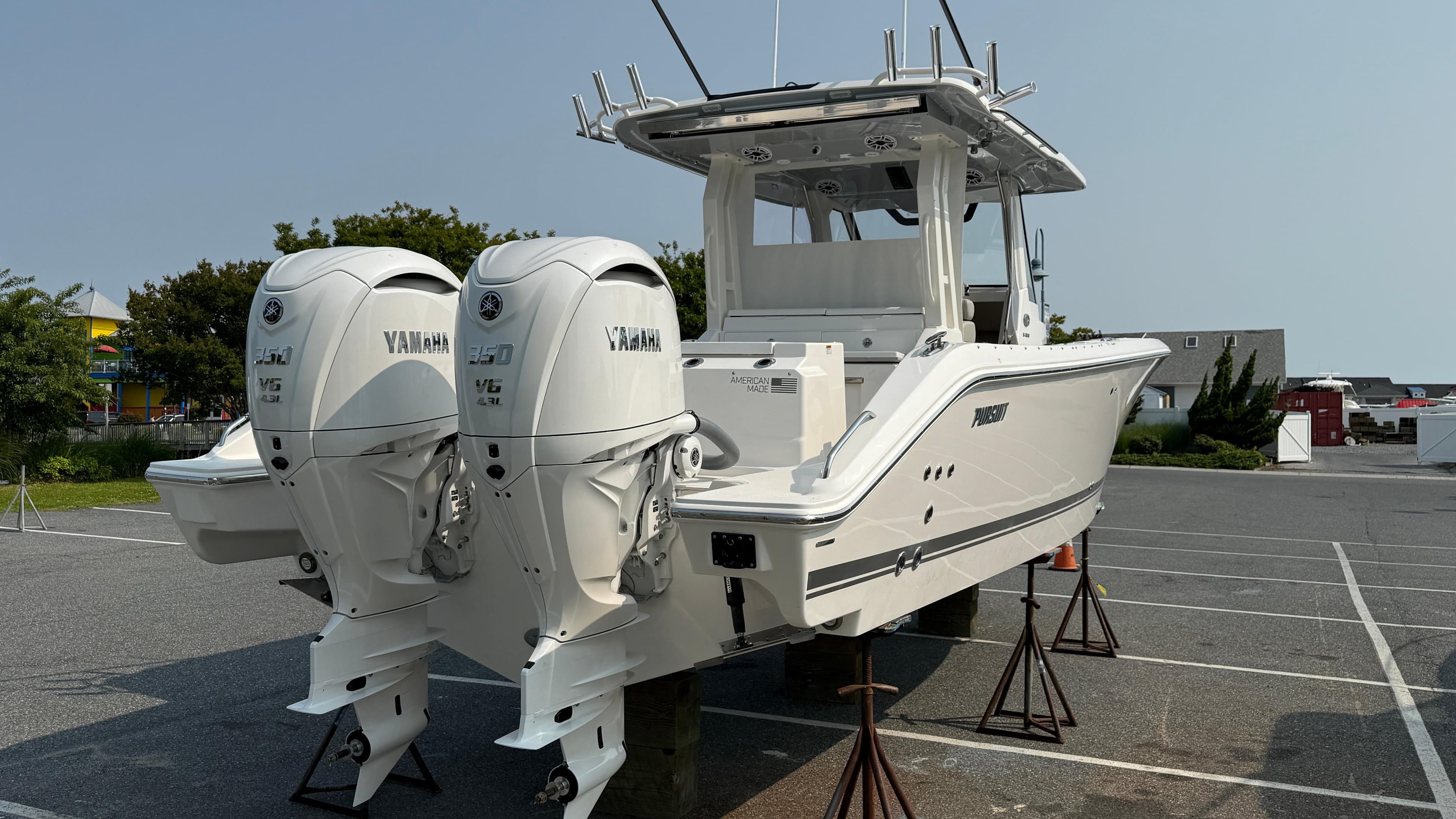 2025 Pursuit S 328 Sport boat with twin Yamaha engines on display.