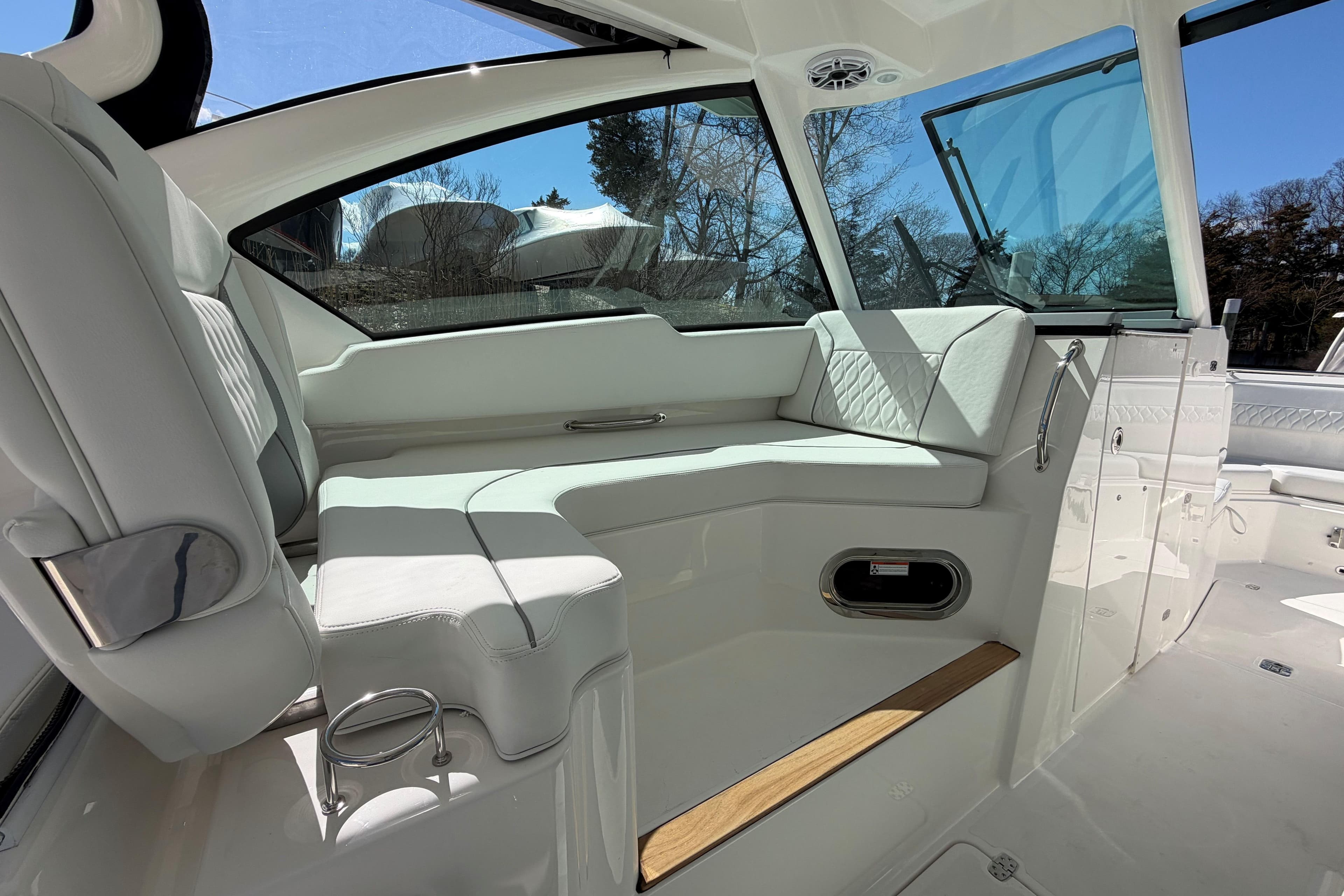 Luxurious interior of 2026 Pursuit DC 326 Dual Console boat with plush seating.