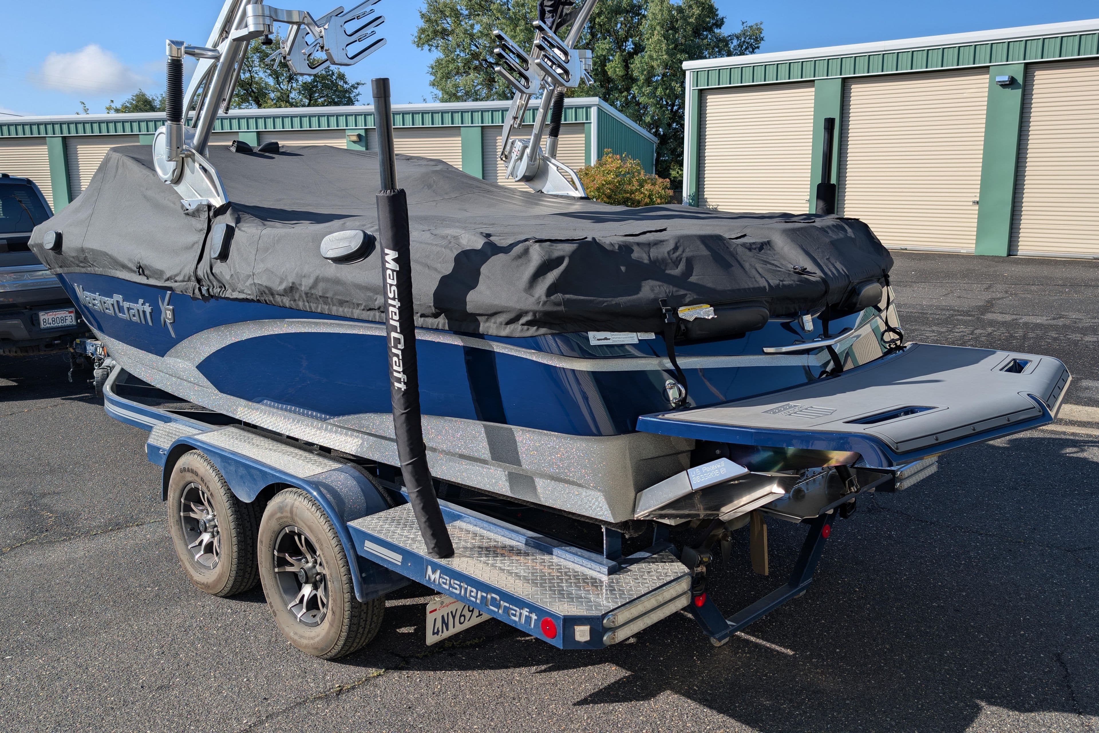 2016 MasterCraft X10 boat on trailer, covered, parked outdoors.
