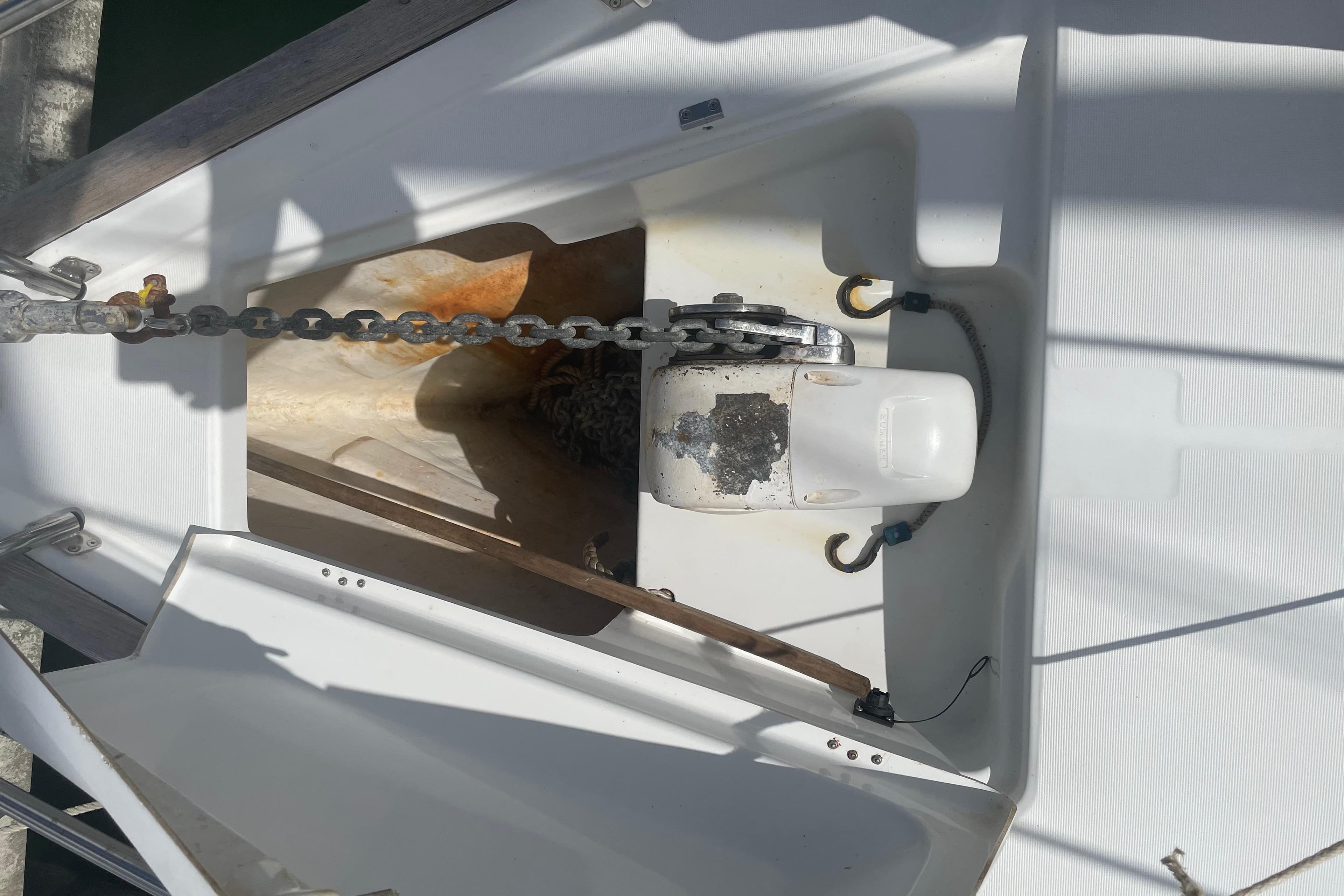 Anchor chain and windlass on a 2007 Beneteau 423 sailboat deck.