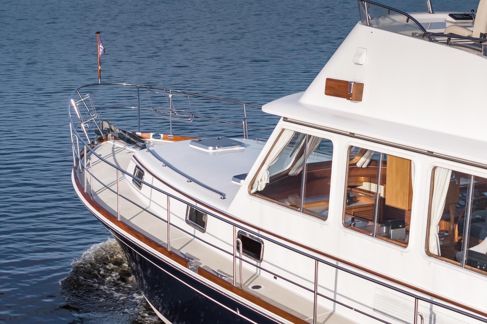 1999 Grand Banks 43 Eastbay FB yacht cruising on calm waters.