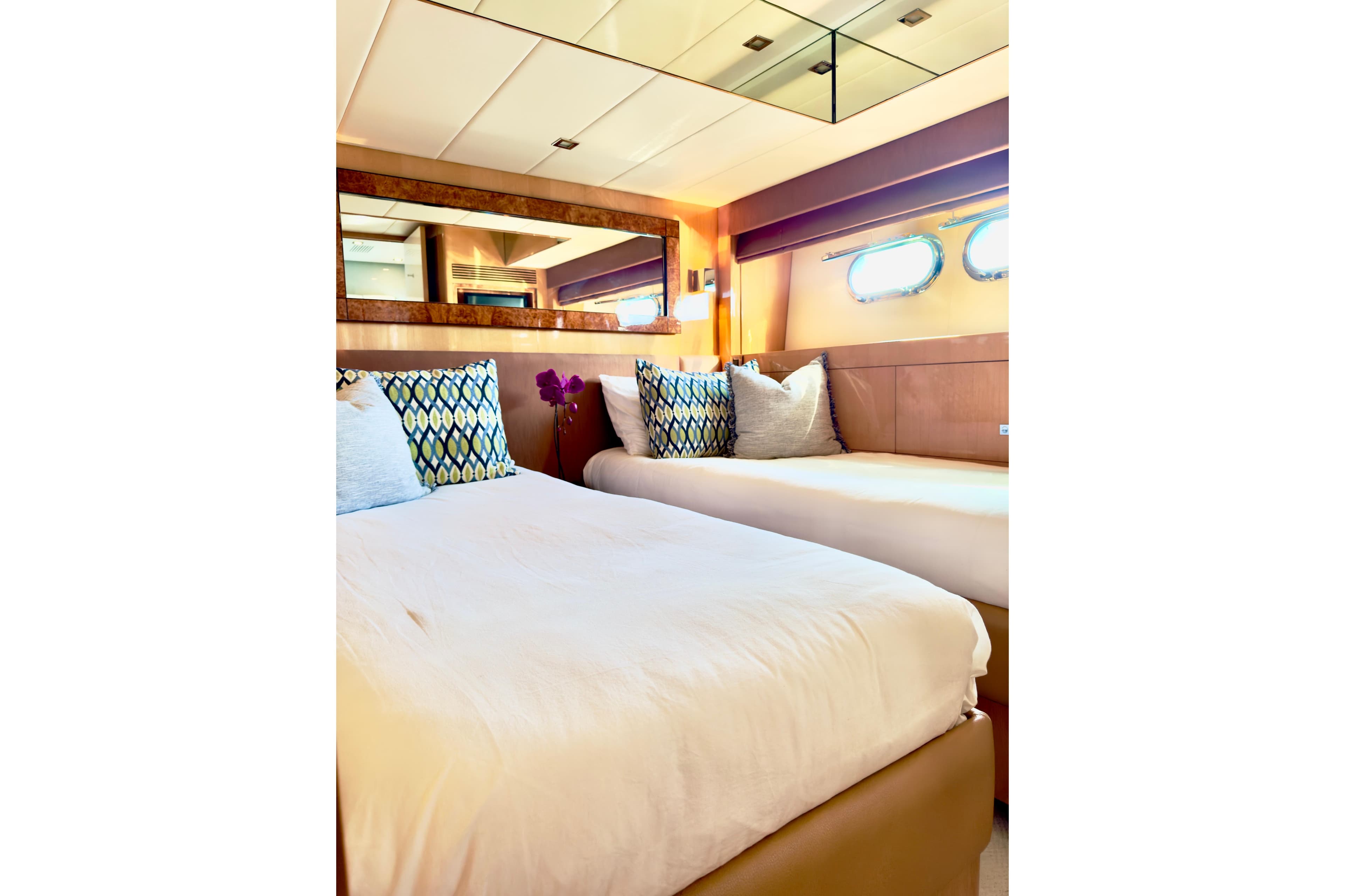 Luxurious bedroom interior on 2011 Horizon E88 yacht with elegant decor and plush bedding.