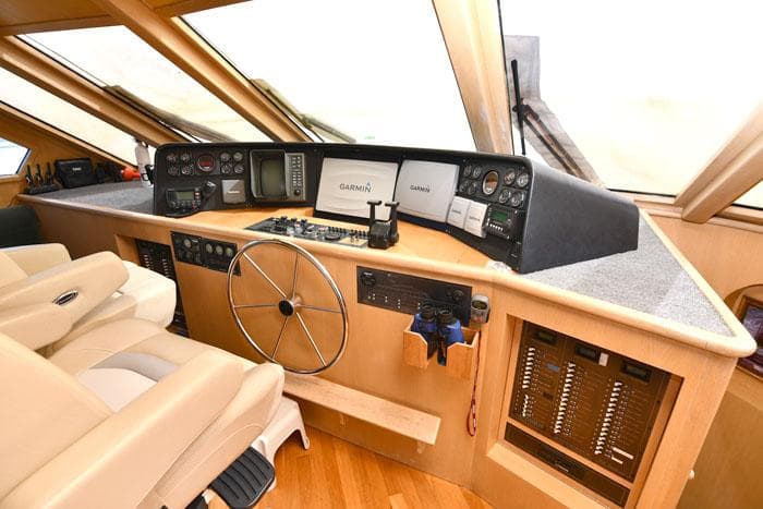 Pilothouse interior of 1997 Forbes Cooper 74, featuring navigation equipment and steering wheel.