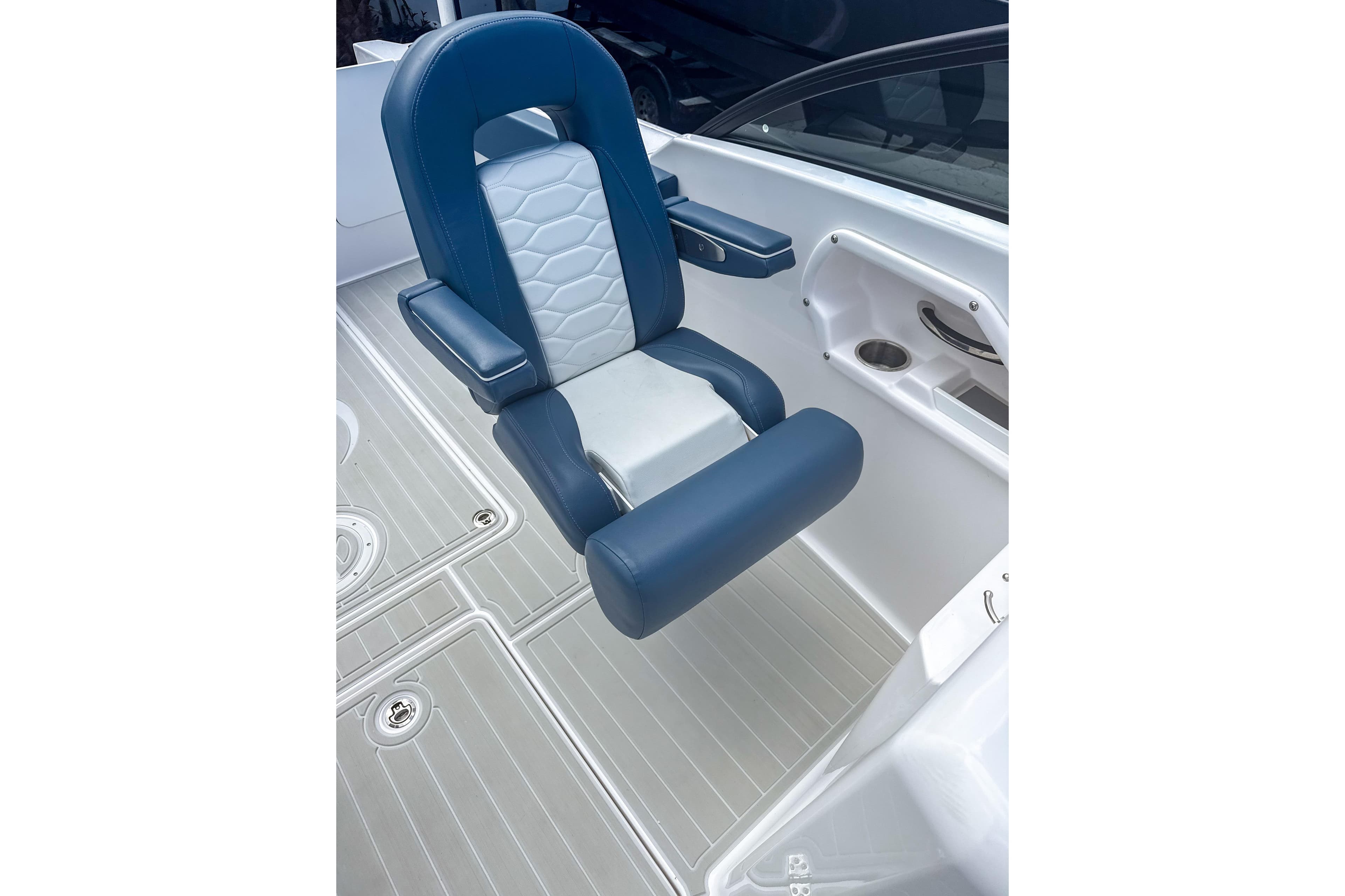 2024 Aquasport AS DC 22 boat seat with blue and white upholstery, cup holder nearby.