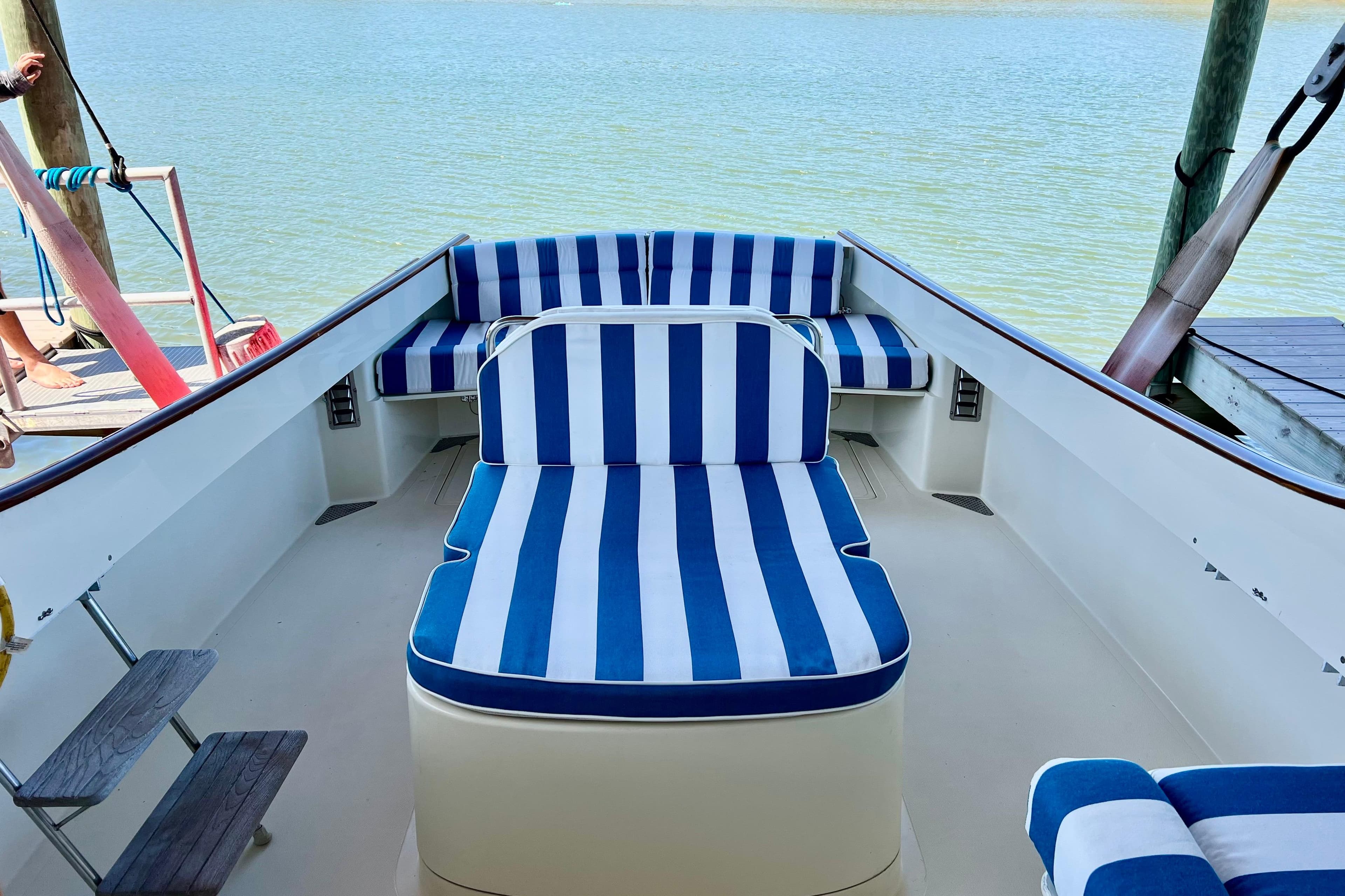 Hinckley Picnic Boat 36 Classic 1995 with blue and white striped seating on deck.