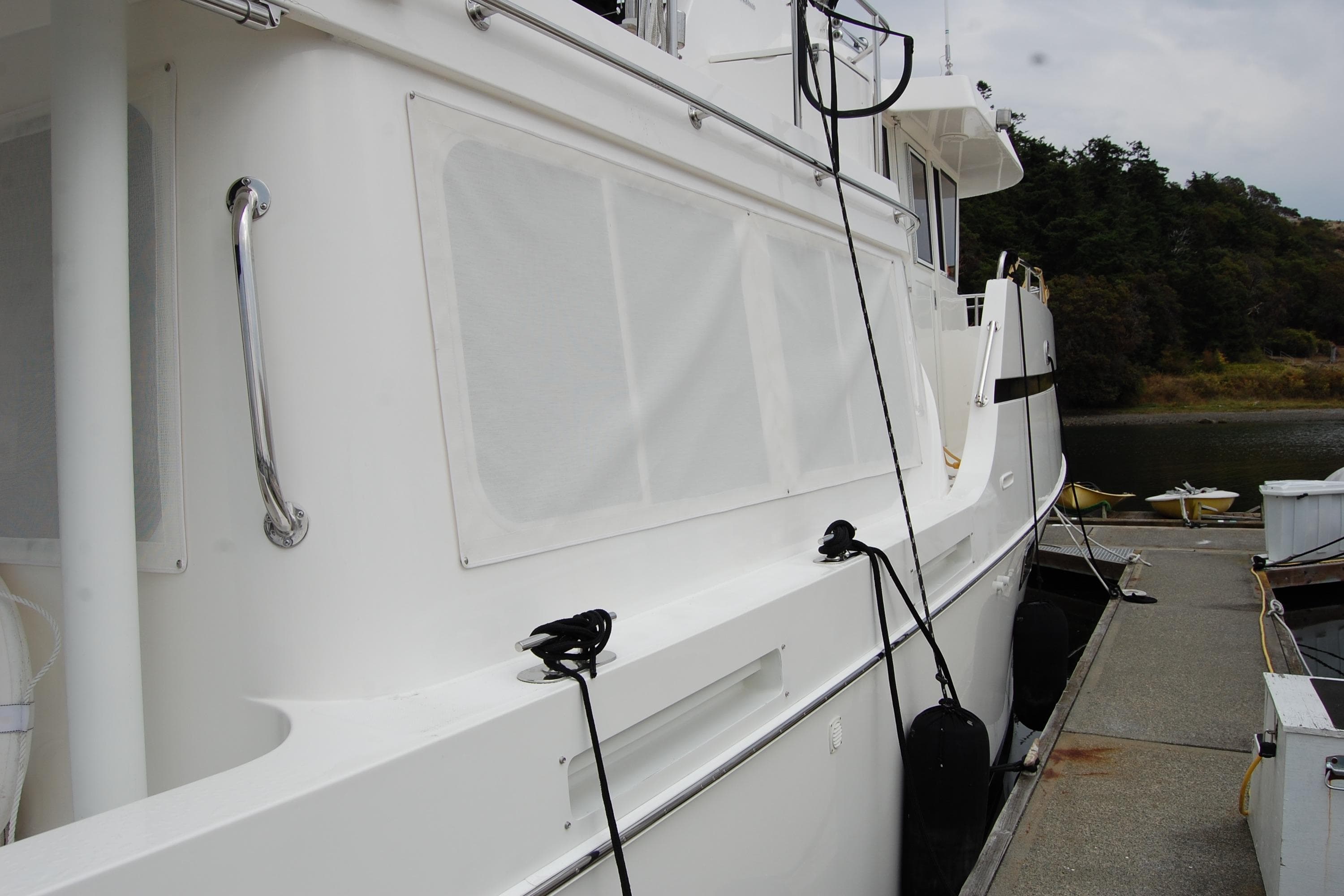 2001 Ocean Alexander Classico yacht docked at marina, side view with white exterior.