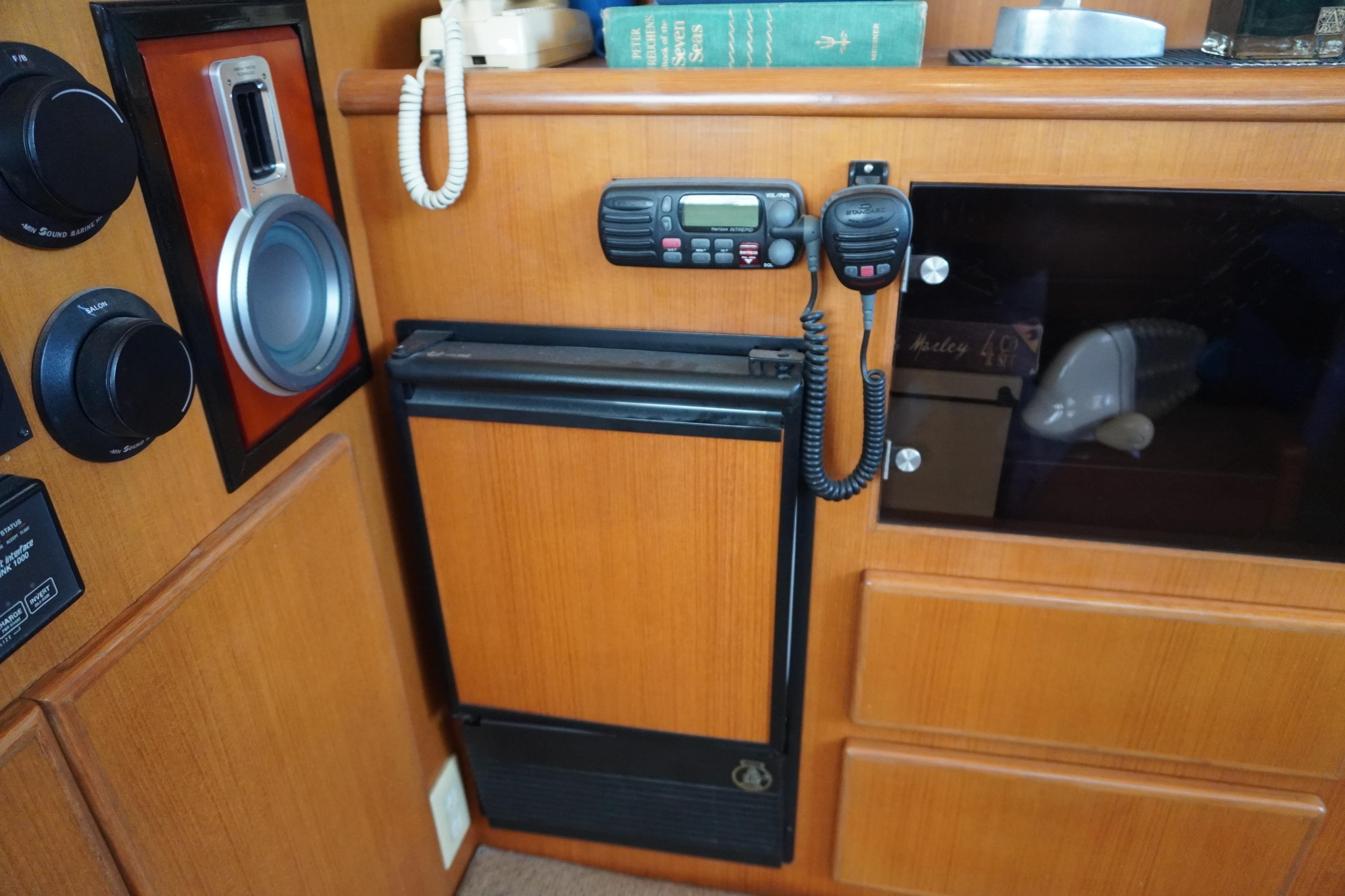 Interior of Symbol 41 yacht with radio and wooden cabinets.