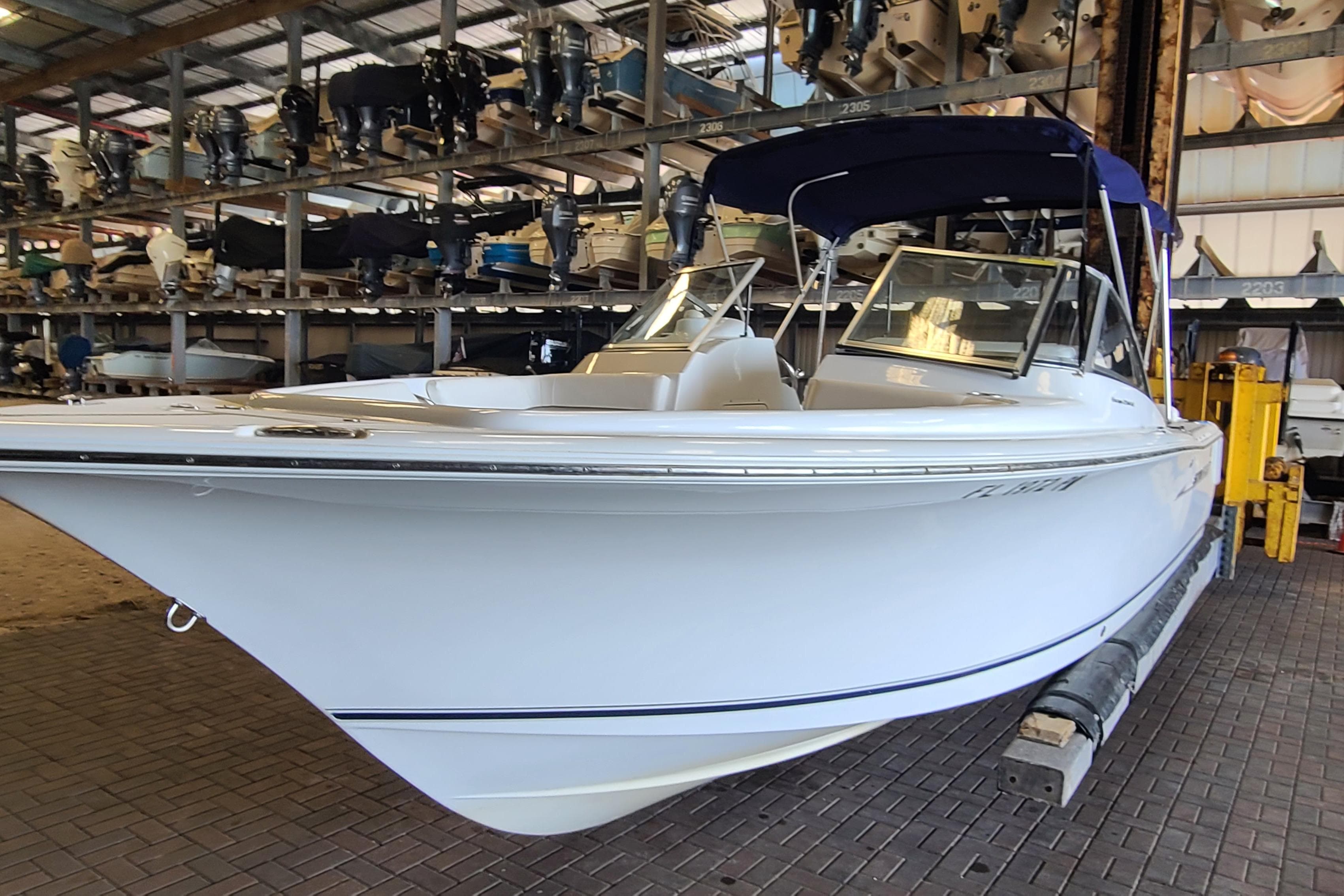 2013 Sea Hunt Escape 234 LE boat in indoor storage facility.
