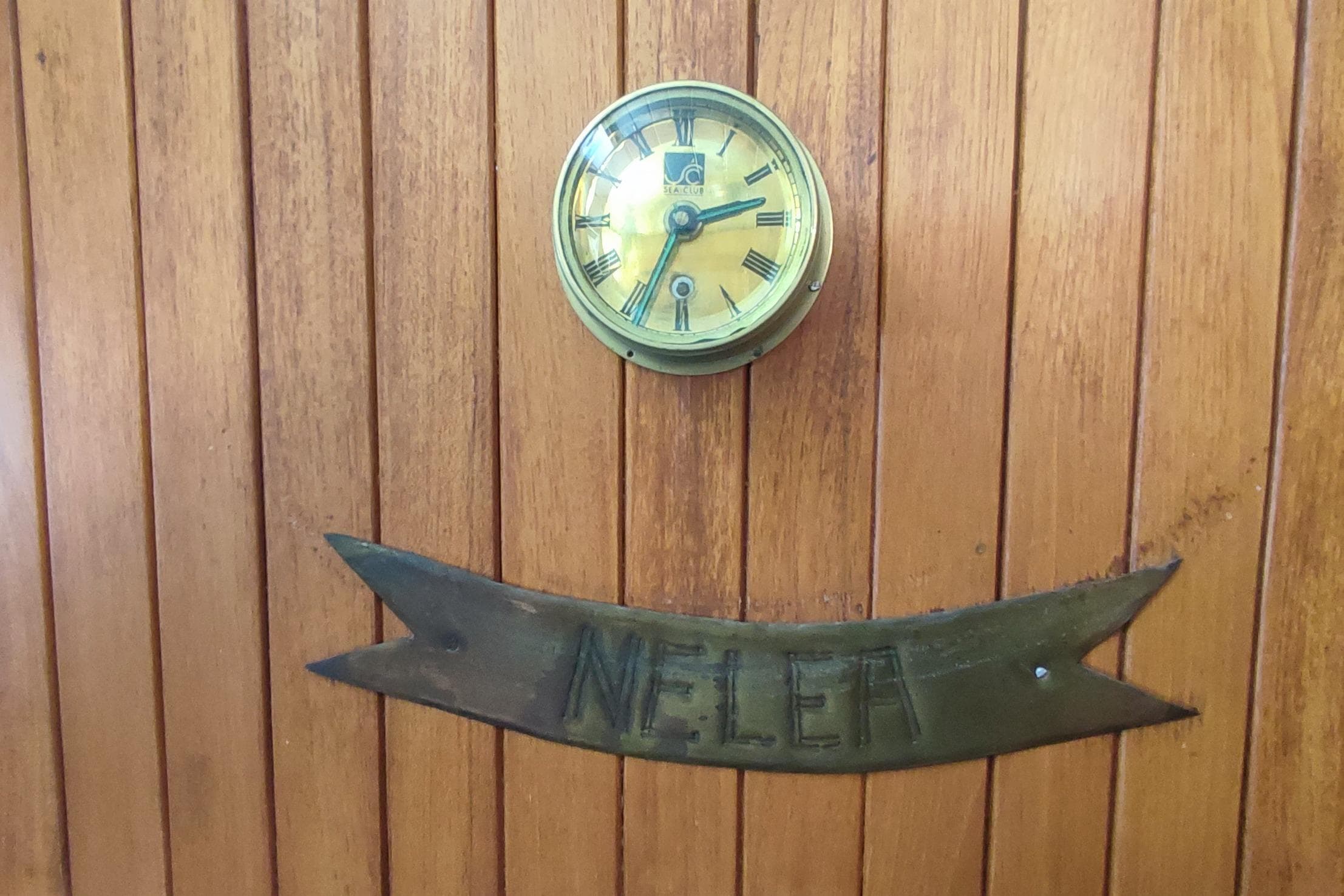 Wooden panel with vintage clock and "NELEA" plaque, Formosa 51, 1980.