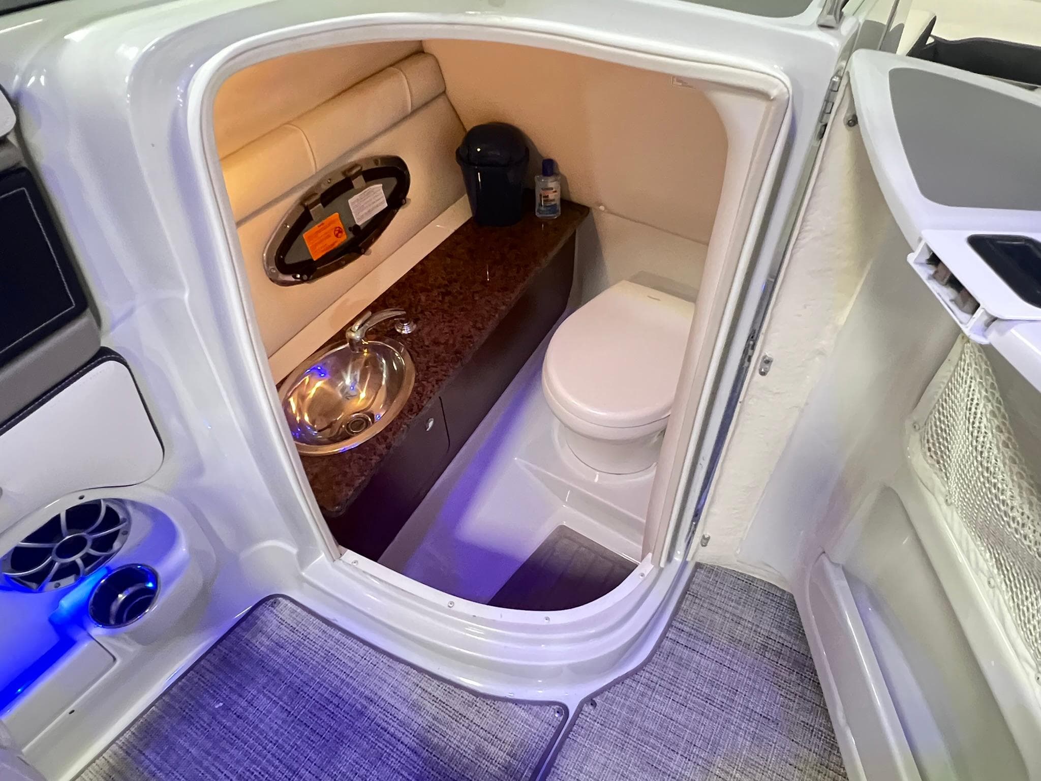 2020 Crownline Eclipse E225 XS boat interior with compact bathroom and sink.
