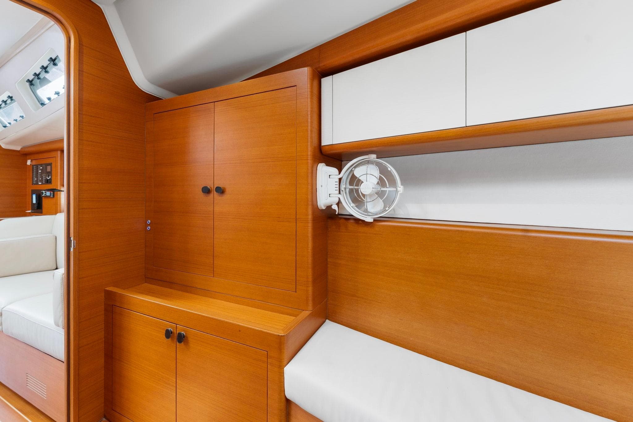 Interior of 2015 Italia Yachts 13.98 with wooden cabinetry and seating area.