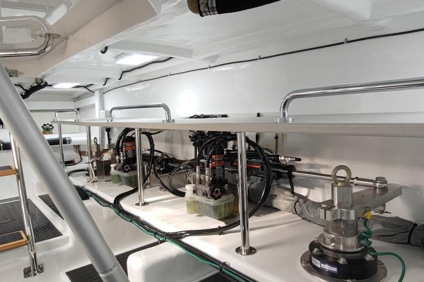 Engine room of 2023 Offshore Yachts 64 ELV, showcasing mechanical components and equipment.
