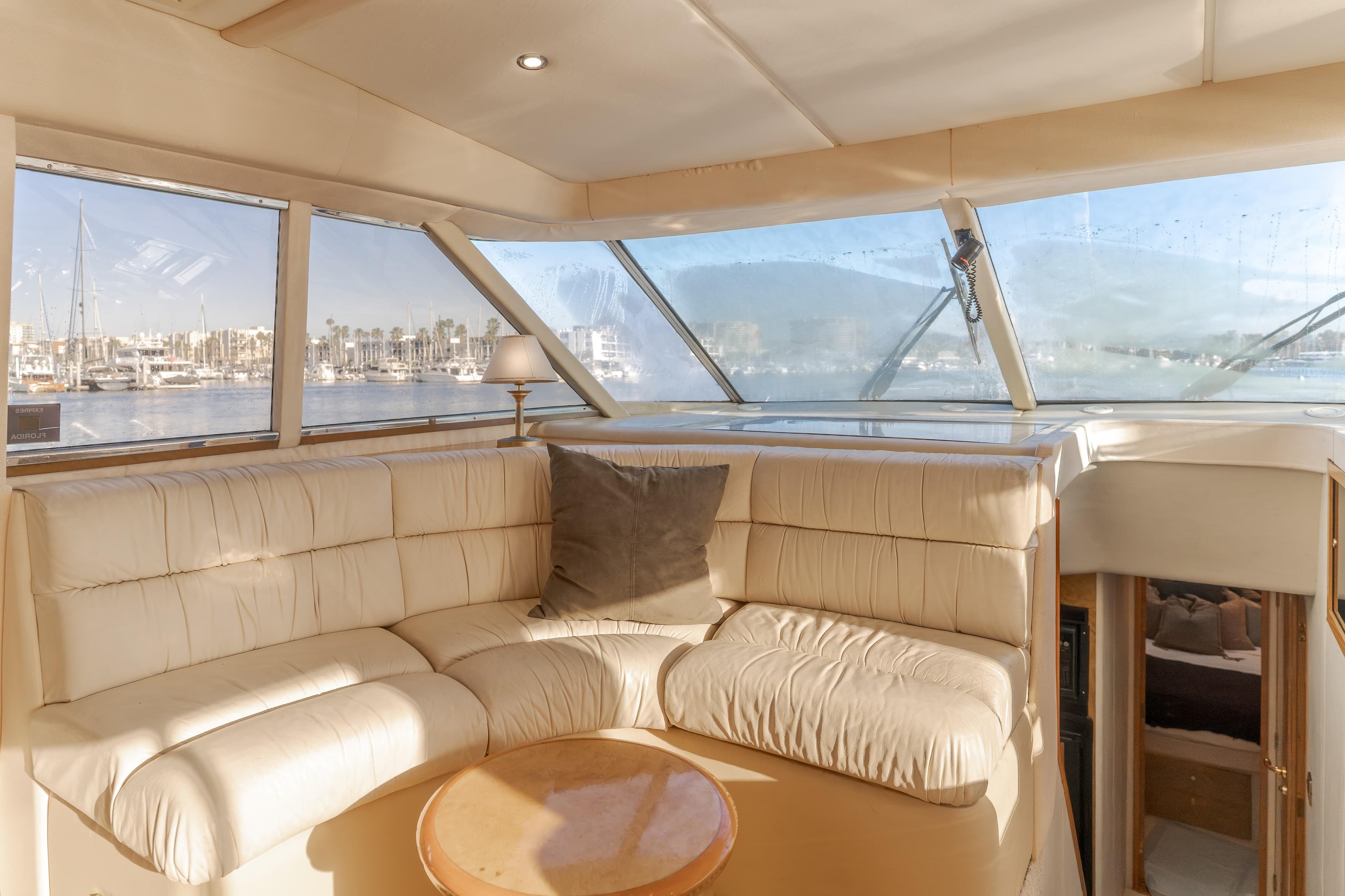 Luxurious interior of 1997 Viking Sport Cruisers 66 Motor Yacht with marina view.