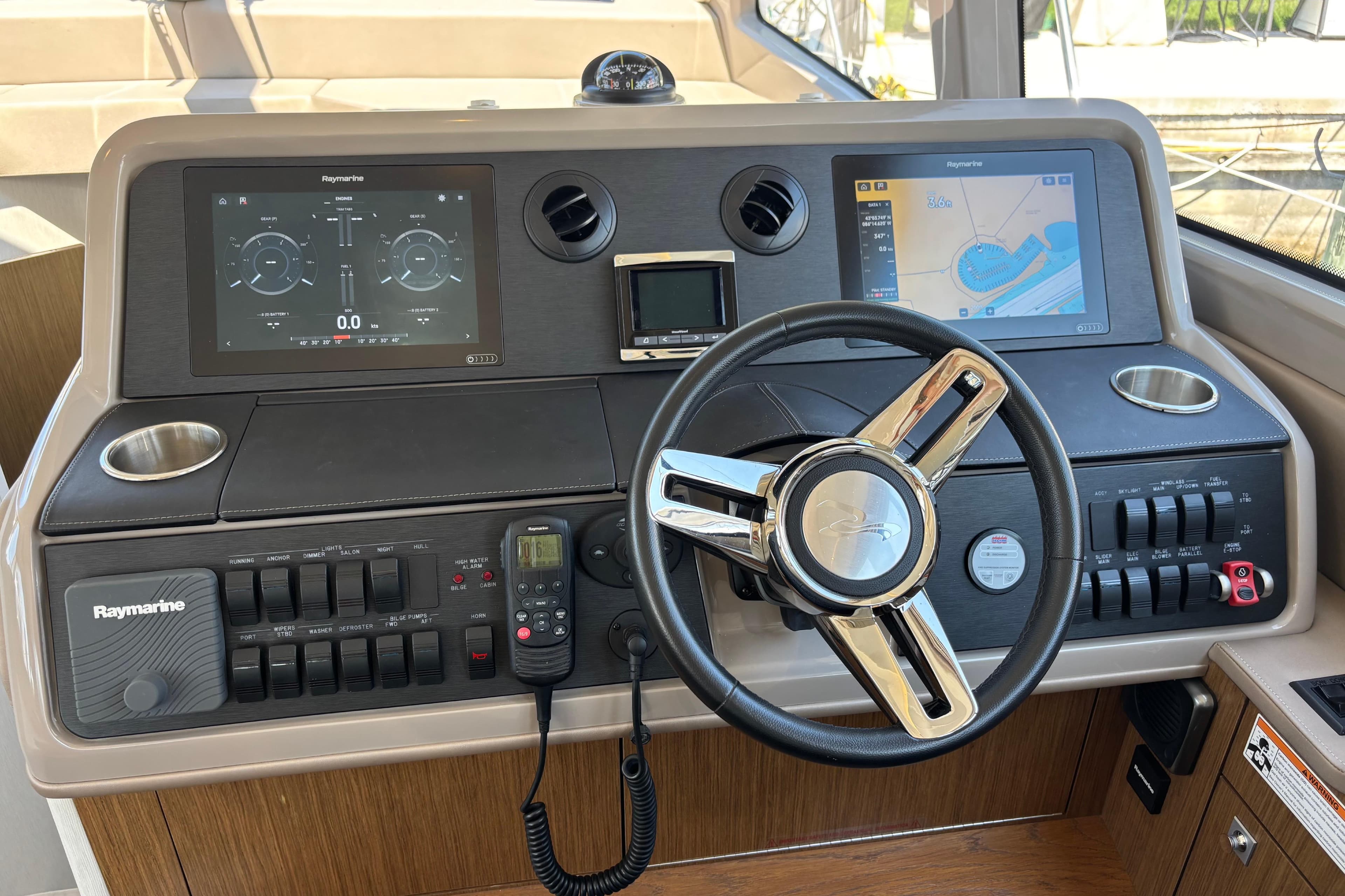 Helm of 2018 Sea Ray Sundancer 460 with Raymarine navigation displays and controls.