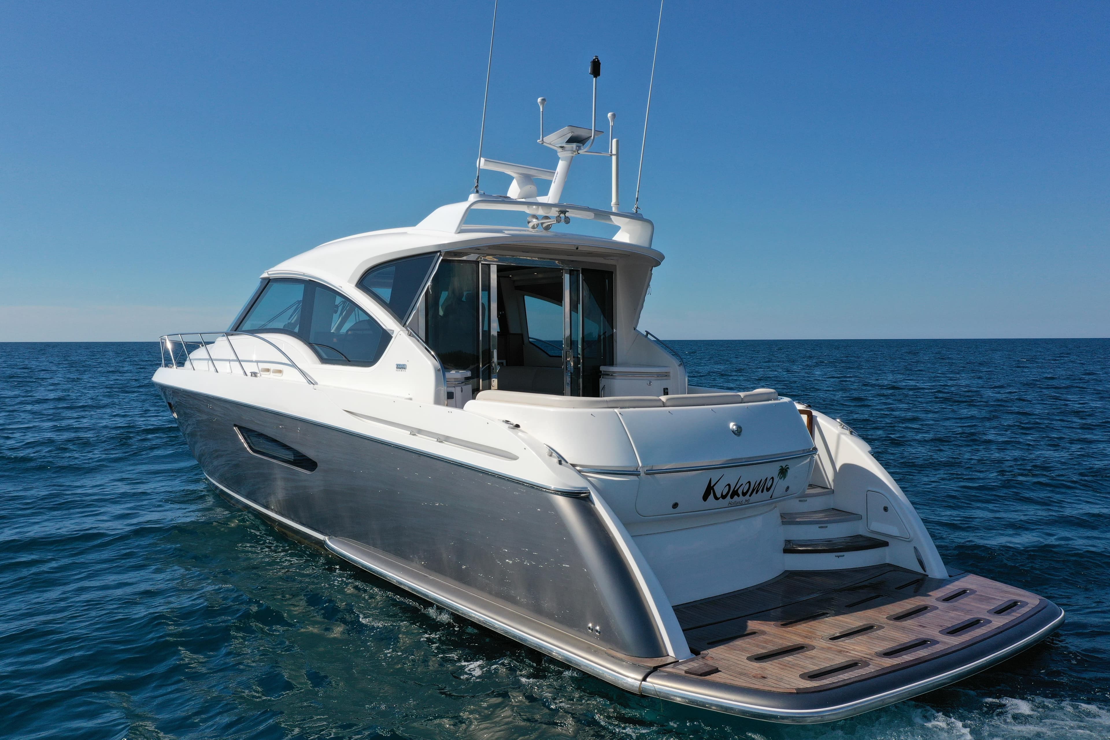 2014 Tiara Yachts 5800 Sovran cruising on open sea under clear blue sky.