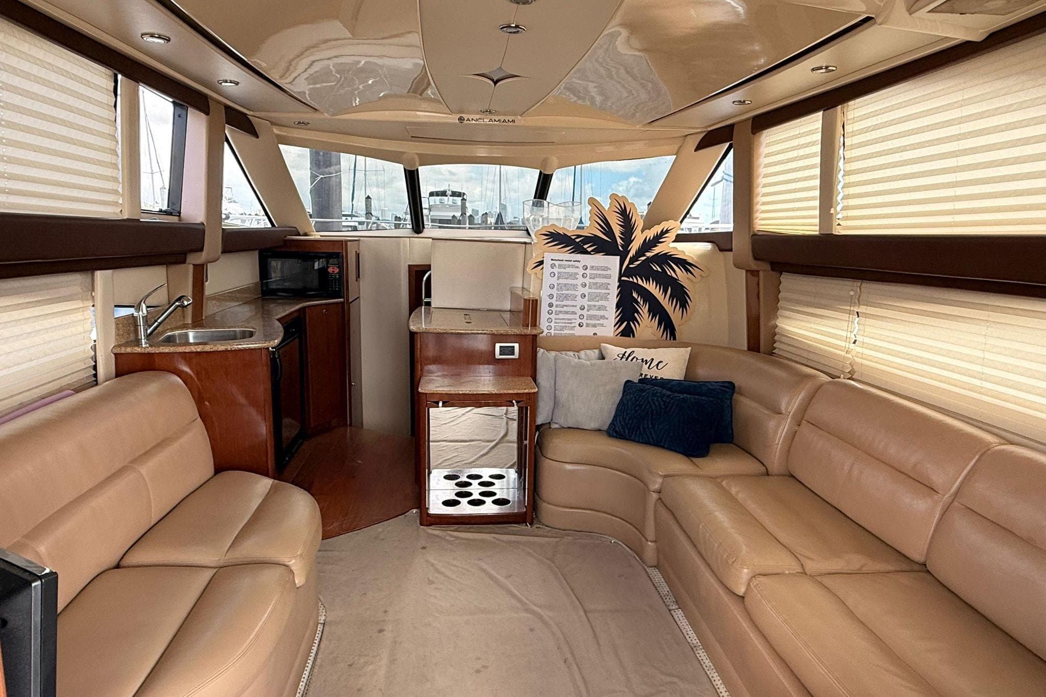 Luxurious interior of a 2008 Meridian 341 Sedan yacht with plush seating and kitchenette.