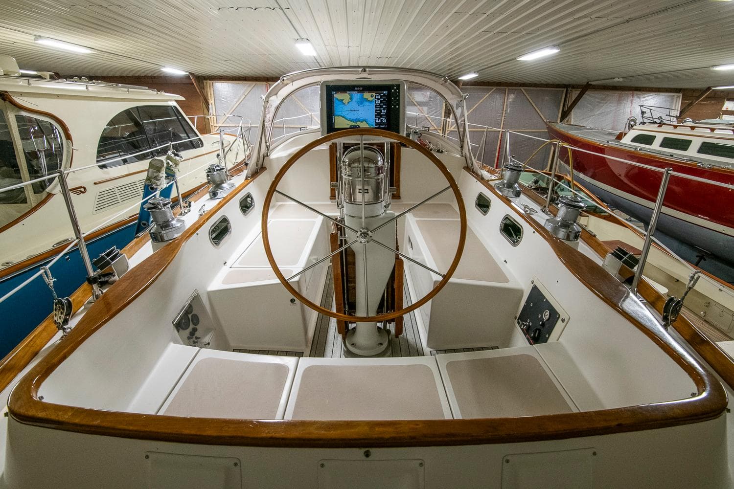 Cockpit of 1994 Hinckley Sou'wester 42 Sloop with wooden wheel and navigation equipment.